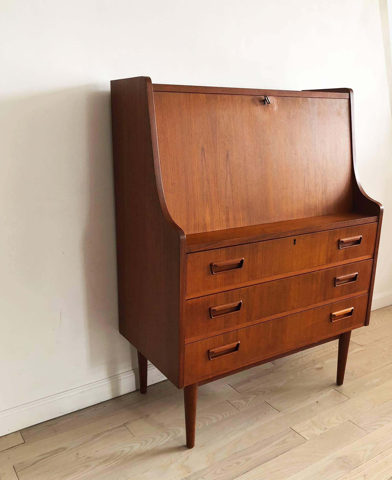 A real beauty. Danish 1960s teak secretary desk designed by Arne Vodder for Sibast sold through Maurice Villency. Perfect condition and lots of storage for a Danish piece. Has the original key which logs the top drawer and the fold down desk. Has