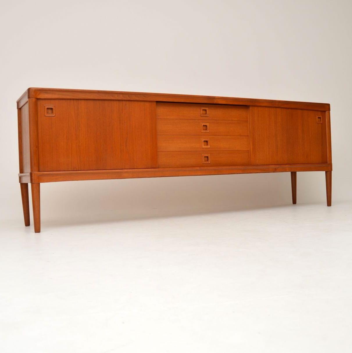 An impressive and extremely well made Danish vintage sideboard in teak, this was designed by Henry Klein and was made in Denmark by Brahmin in the 1960s. The quality is phenomenal, and the condition is immaculate, we have had this stripped and