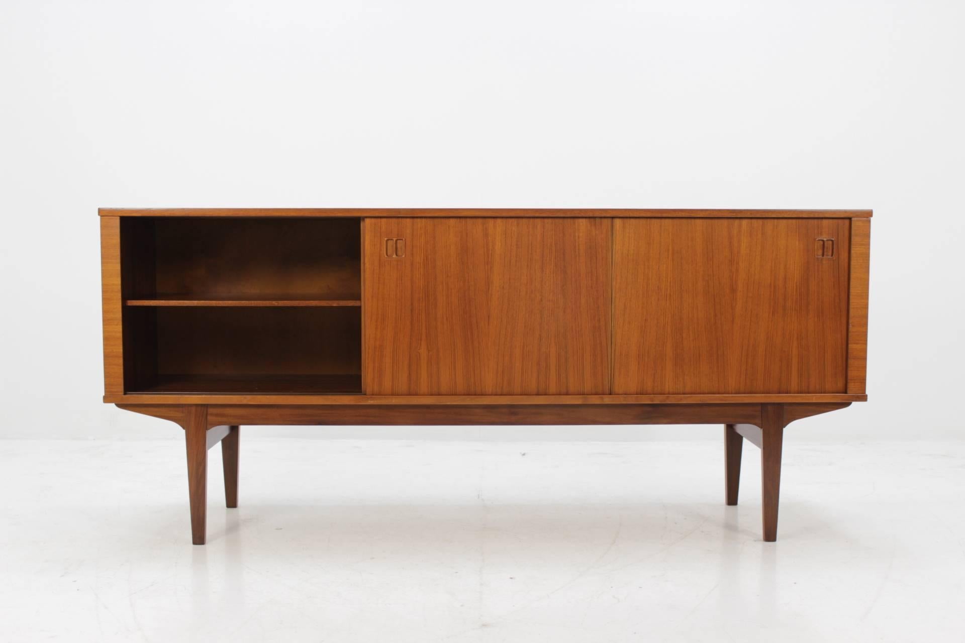 This sideboard features two sliding doors, four shelves and four drawers. This item was carefully restored.