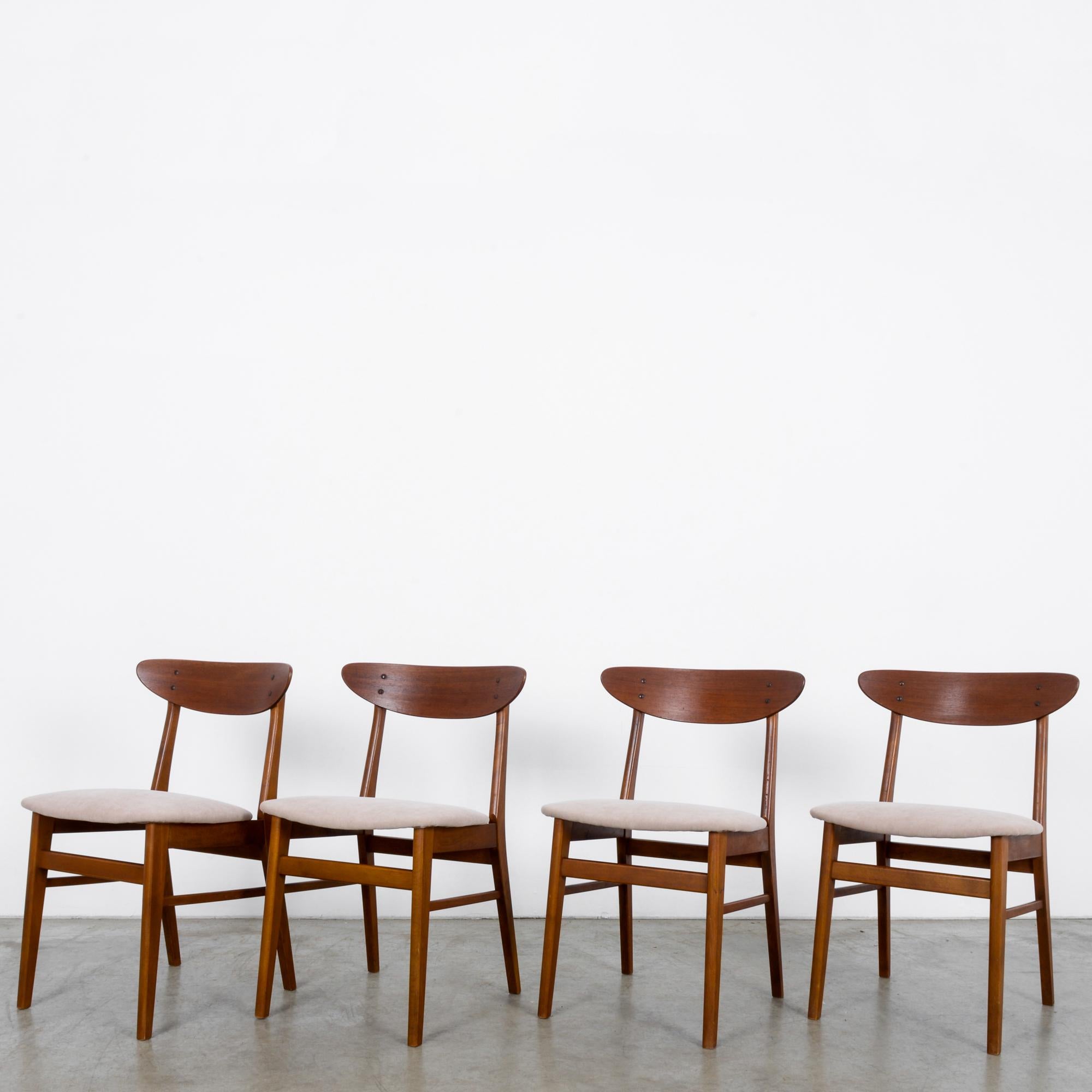 This set of four chairs from Denmark circa 1960 is Classic Scandinavian Modern design. Freshly re-upholstered and looking like the seat backs were scooped raw off the side of a tree, the sleek clean lines of these chairs will add grace to any