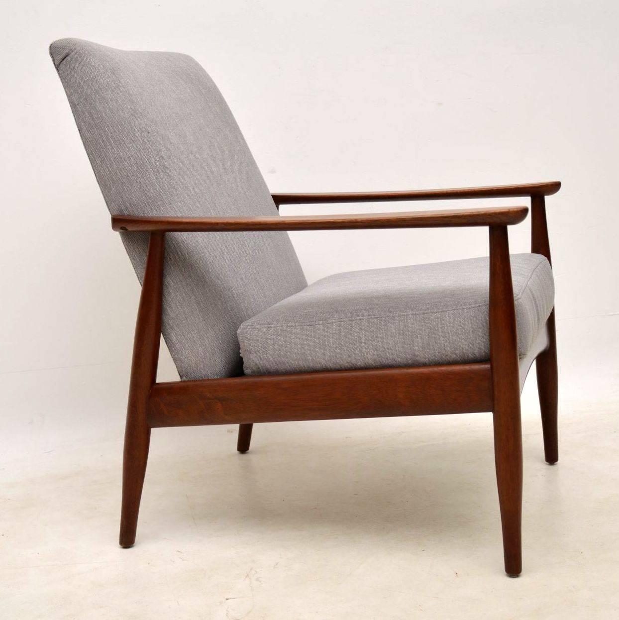 A stylish and comfortable Danish vintage armchair, this dates from the 1960s. The frame is solid Afromosia wood, we have had this newly upholstered in a lovely light grey fabric. The frame is clean, sturdy and sound, with only some very minor wear