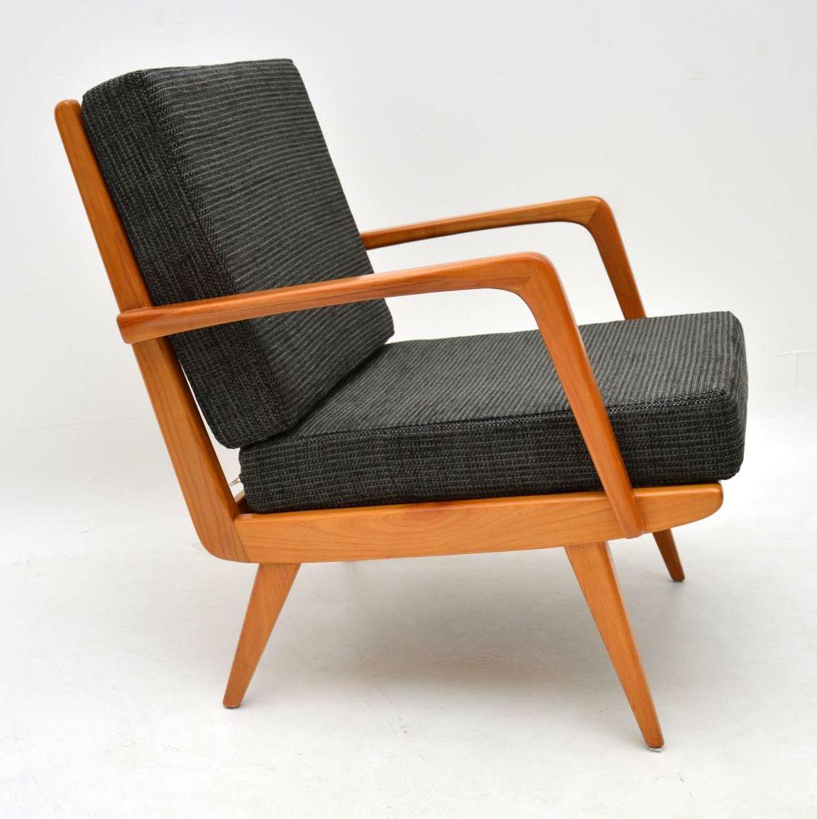 A stylish vintage Danish armchair dating from the 1960s, in solid cherrywood. We have had the frame stripped and re-polished to a very high standard, the cushions have been newly made and upholstered in a lovely charcoal fabric. The condition is