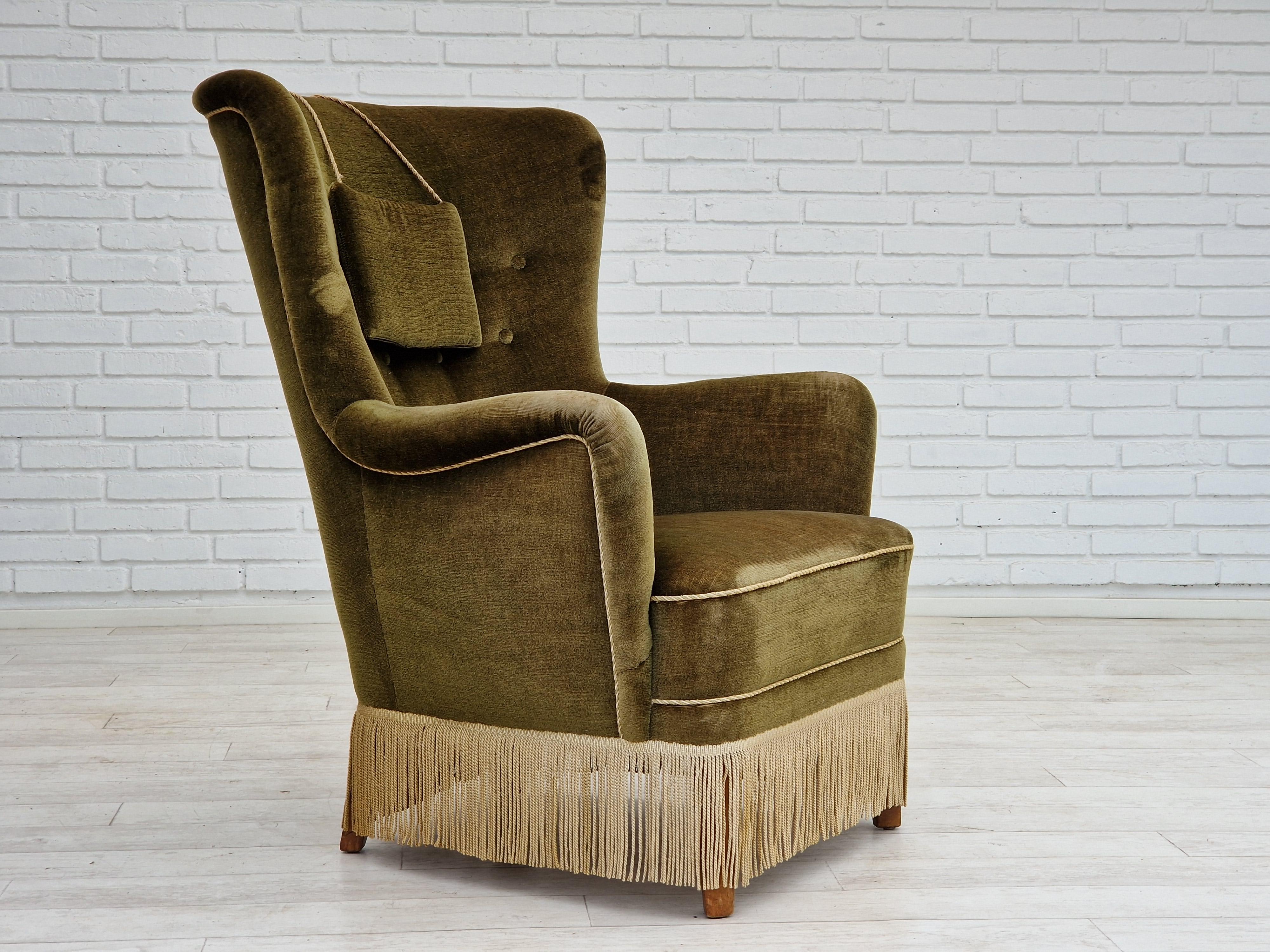 1960s, Danish design. Highback armchair in original good condition: no smells and no stains. Original green velour, springs in the seat, beech wood legs. Light wear/patina on armrest. Made by Danish furniture manufacturer in about 1960.