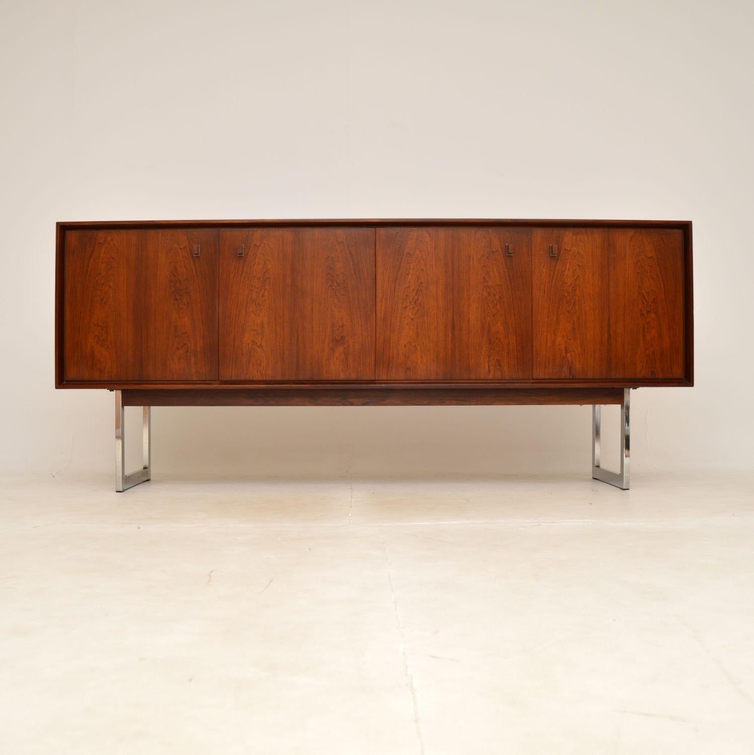 A stylish and extremely well made vintage Danish sideboard. This was recently imported from Denmark, it dates from the 1960s.

It is of superb quality, the wood has stunning grain patterns and a gorgeous colour tone. This sits on beautifully