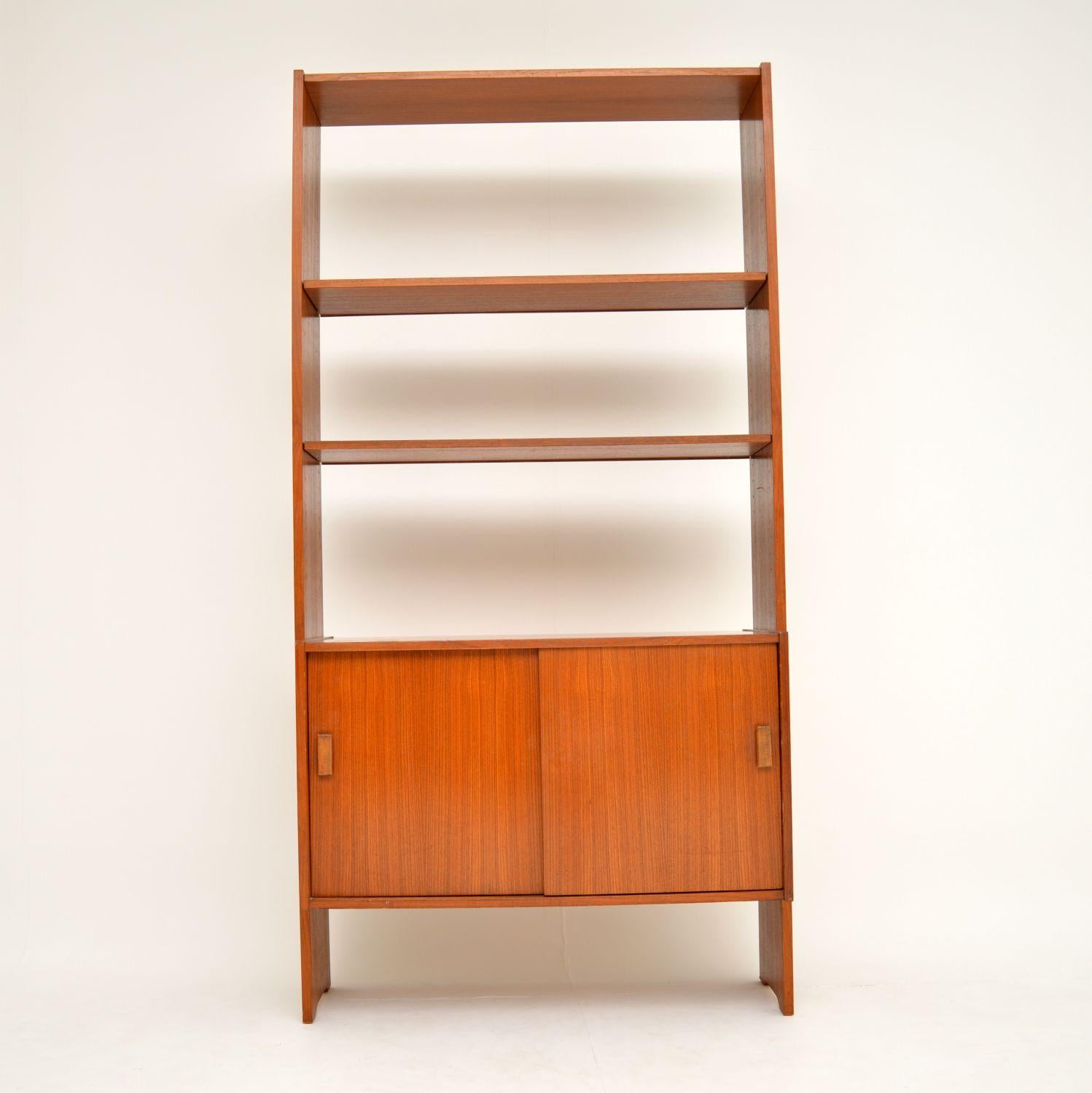 A smart and stylish vintage Danish bookcase in teak, this dates from the 1960s. It’s in lovely original condition, with only some light surface wear and a few very minor marks here and there. The lower cabinet has two sliding doors, and has a