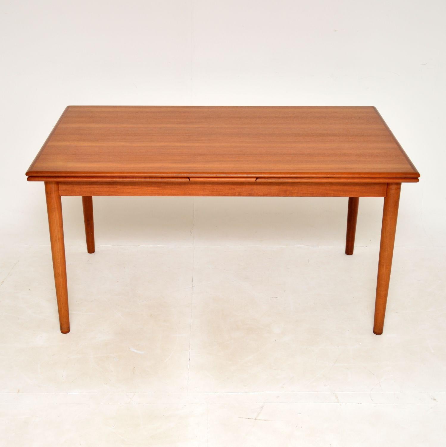 A superb Danish vintage extending dining table in teak. This was made in Denmark, it dates from the 1960’s.
It is of excellent quality and is a great size. There are leaves at each end that slide out to extend this, it can comfortably seat ten when