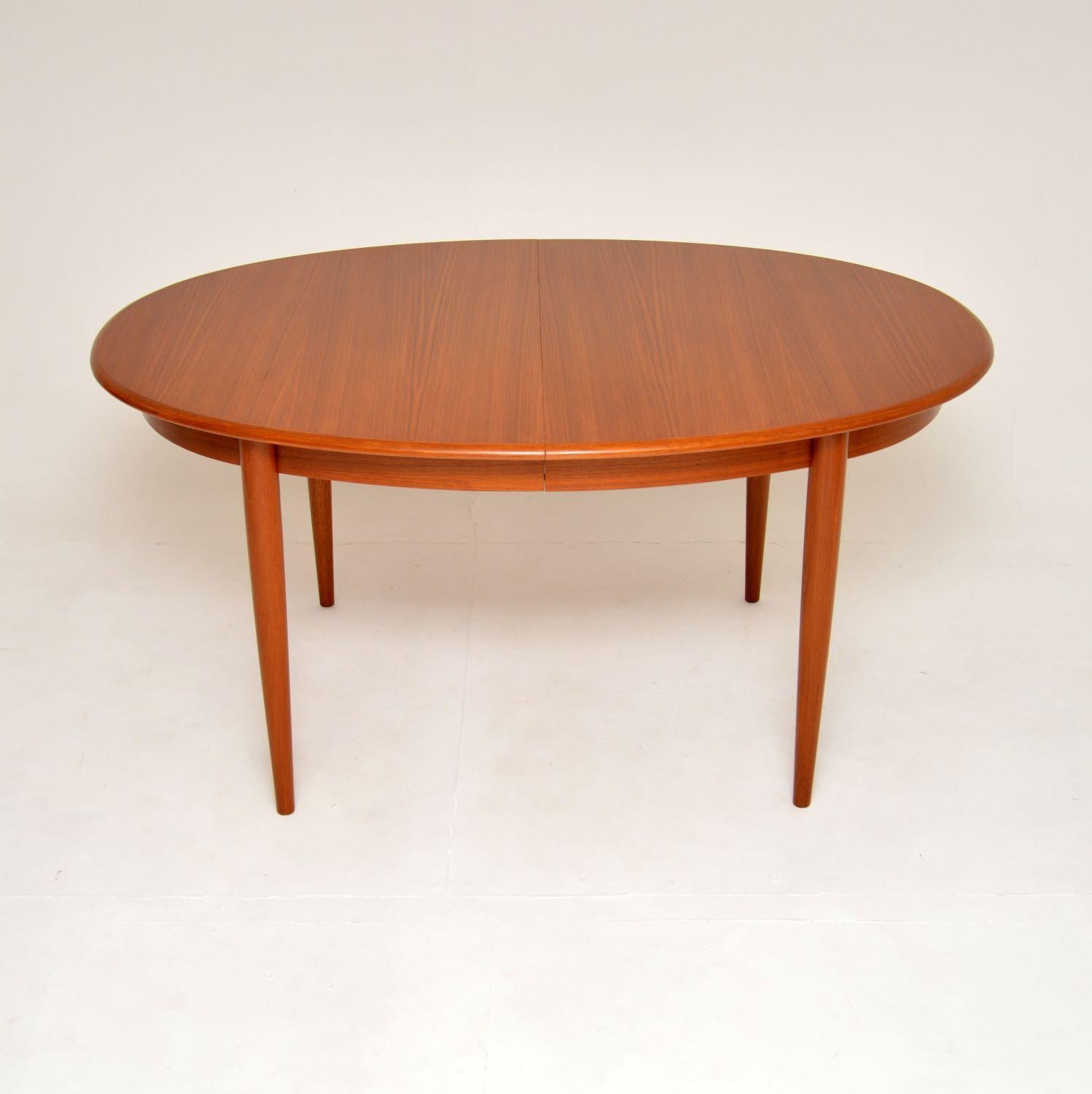 A stylish and extremely well made vintage Danish teak extending dining table. This was made in Denmark, it dates from the 1960’s.

It is a great size, with a sleek oval top sitting on beautifully tapered legs. There are two extension leaves that