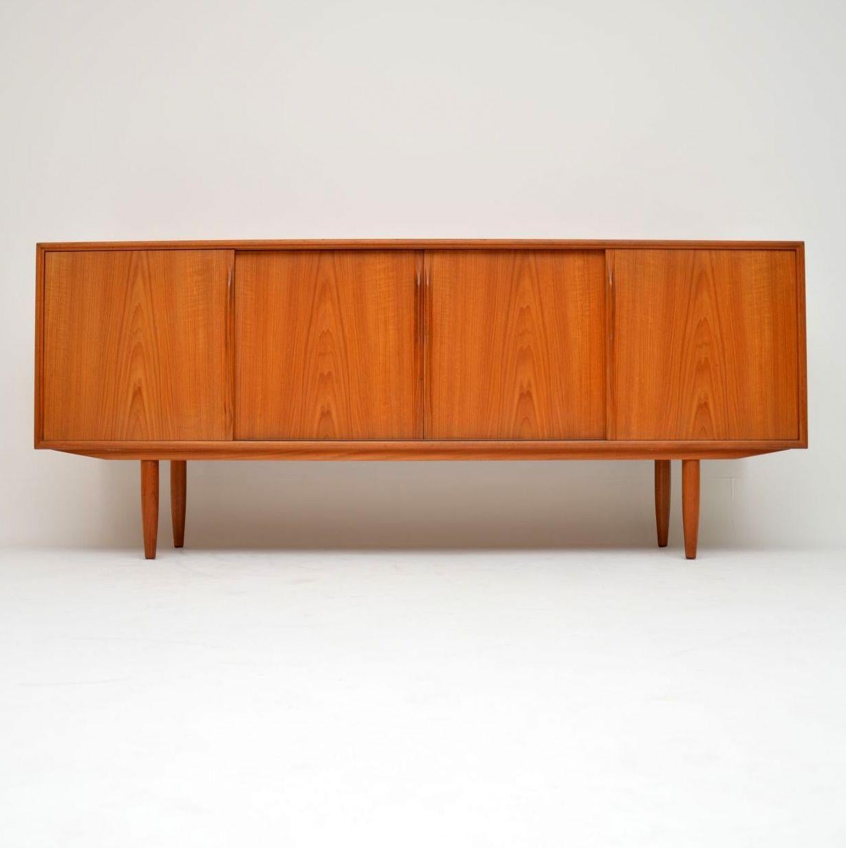 A super stylish and extremely well made vintage Danish sideboard in teak, this was designed by Gunni Omann for Omann Junior. It was made in Denmark during the 1960s, and is in superb condition for its age. It came out of a private London house, the