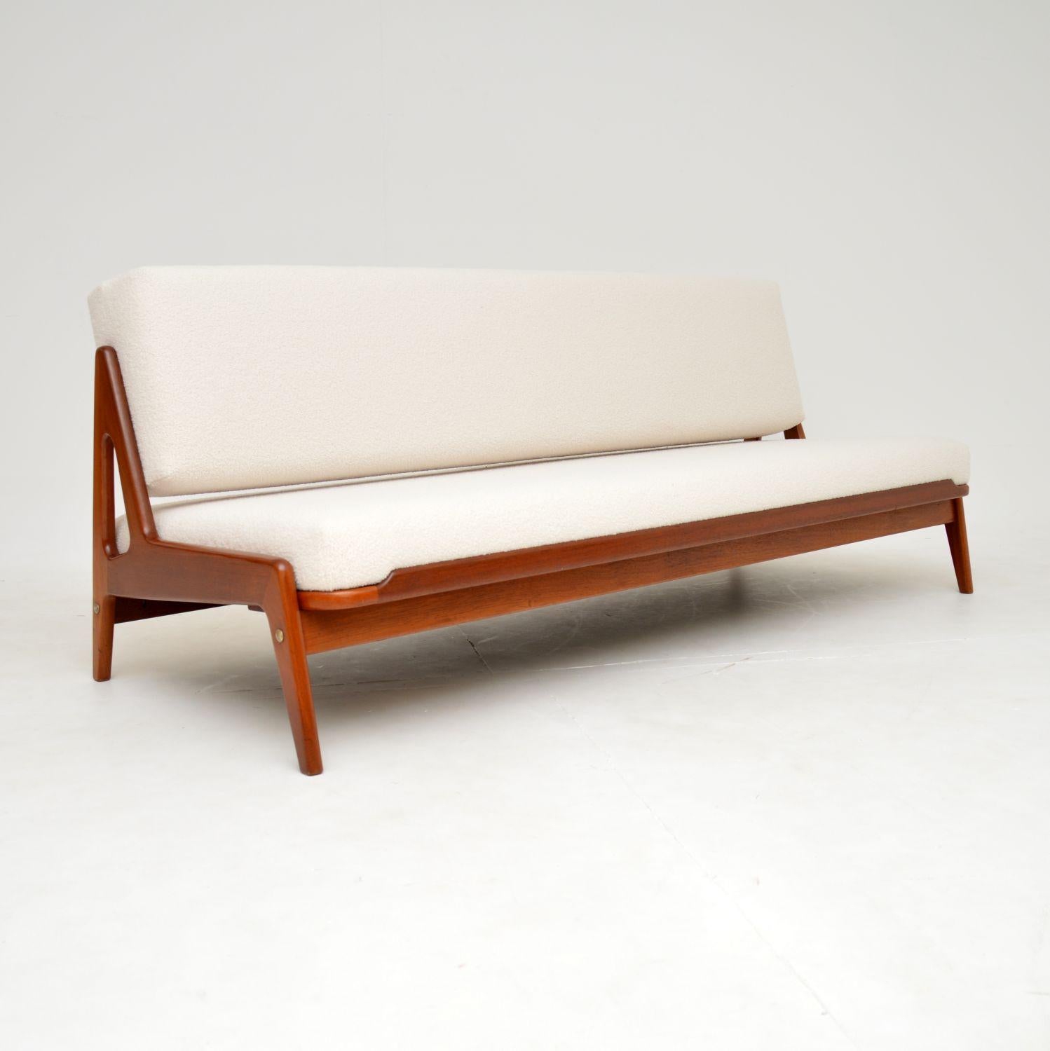 A beautiful and very rare vintage Danish sofa bed in teak. This was made in Denmark by Komfort, it was designed by Arne Wahl Iversen and dates from the 1960-70’s.

The quality is fantastic, this has a very stylish and clever design. The seat pulls