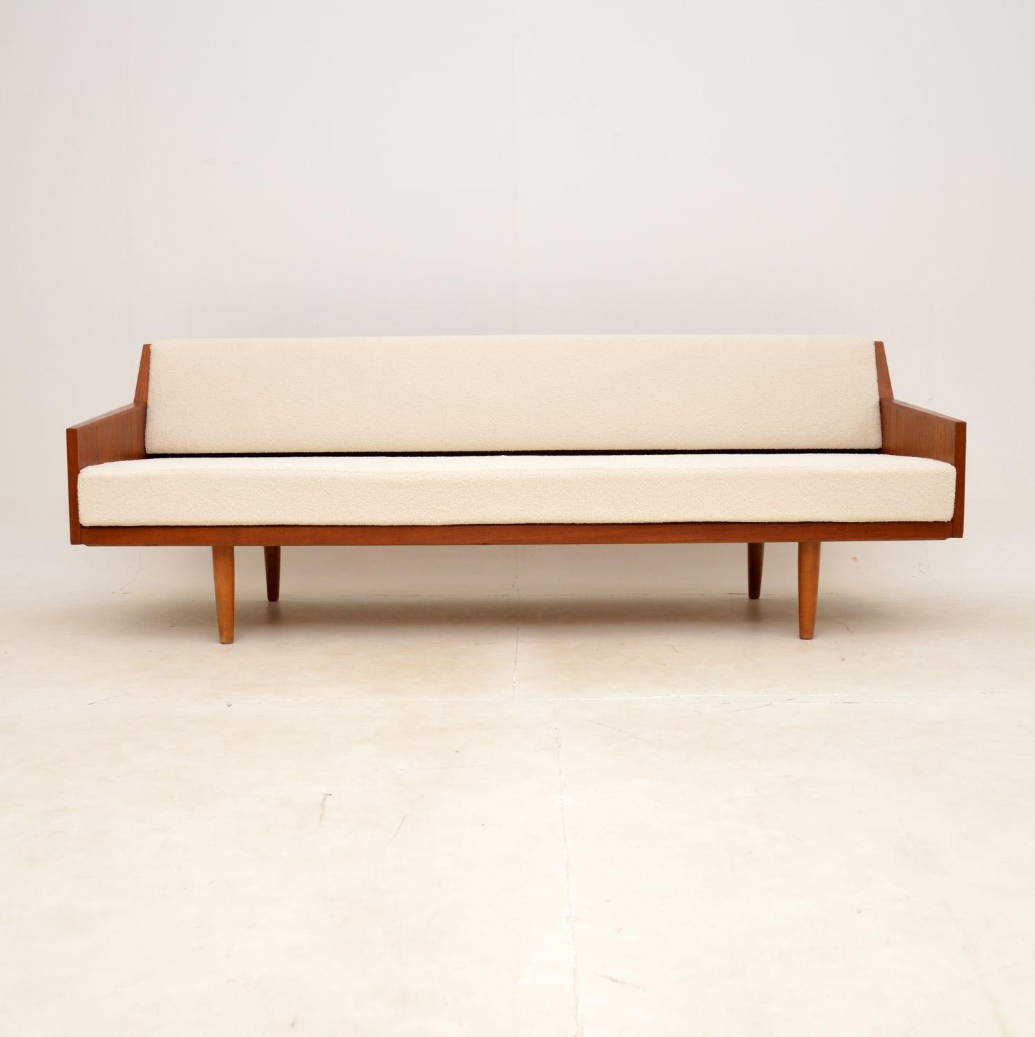 A stunning vintage Danish sofa bed in teak. This was made by Horsens mobelfabrik, it dates from the 1960s.

This has a stylish and very clever design, with beautiful panelled teak sides. The back has a mechanism which two pins are released and the