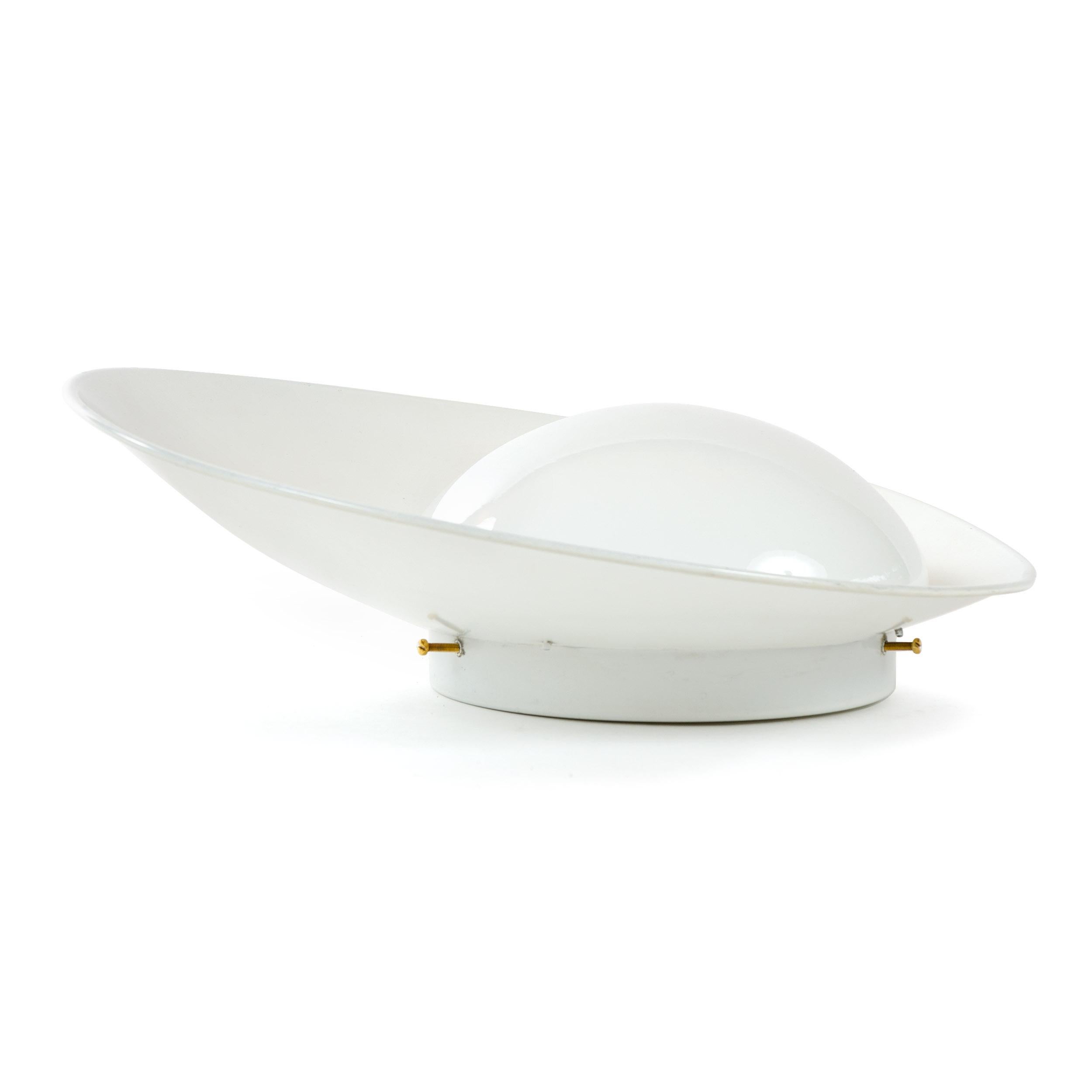 A wall sconce having a half globe crowned by a white lacquered asymmetrically angled shade.