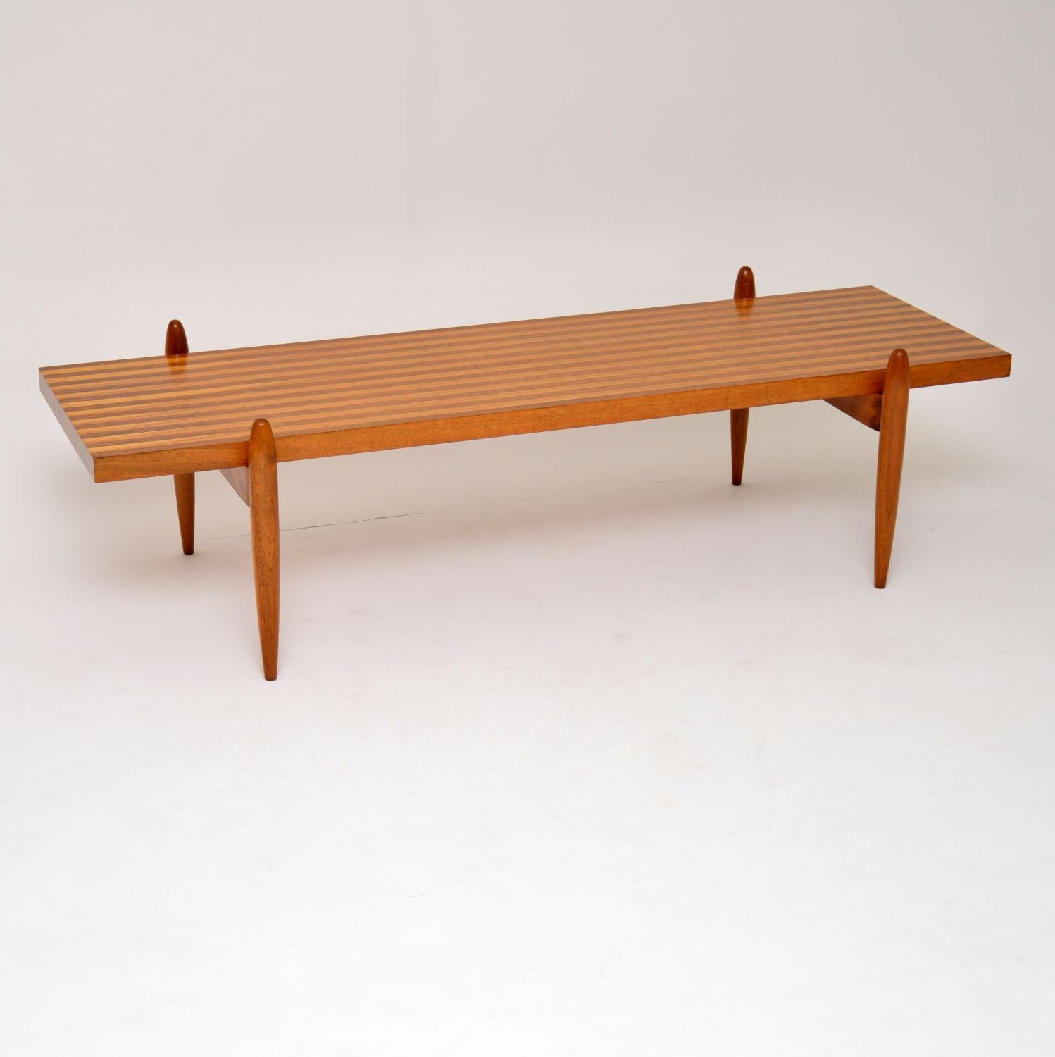 A stunning and rare vintage coffee table with an absolutely amazing design, this was made in Denmark and dates from the 1960s. The top is made from strips of solid walnut and solid elm, and it sits on a very interesting base. We have had this