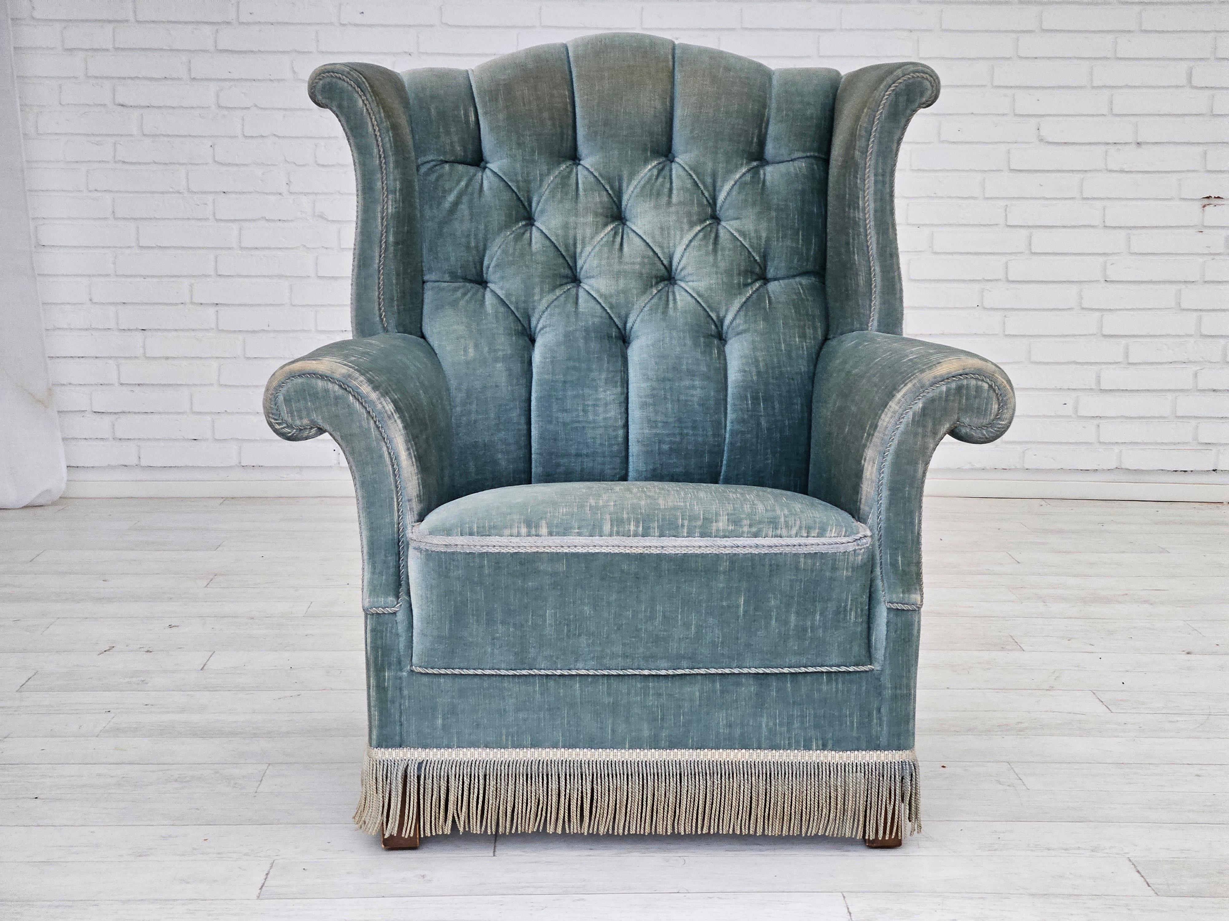 1950-60s, Danish wingback armchair in original light blue velour. Original good condition with nice patina: no smells and no stains. Beech wood legs, springs in the seat. Manufactured by Danish furniture manufacturer in about 1955s.