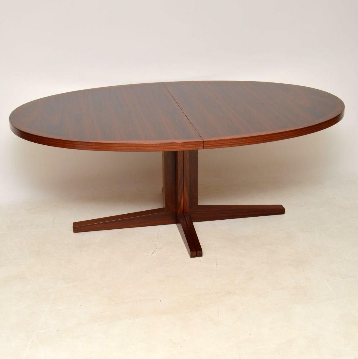 A stunning and top quality Danish wood vintage dining table, this was designed by John Mortensen for Heltborg mobler. It dates from the 1960s and is in absolutely superb condition throughout, we have had this fully stripped and re-polished to a very