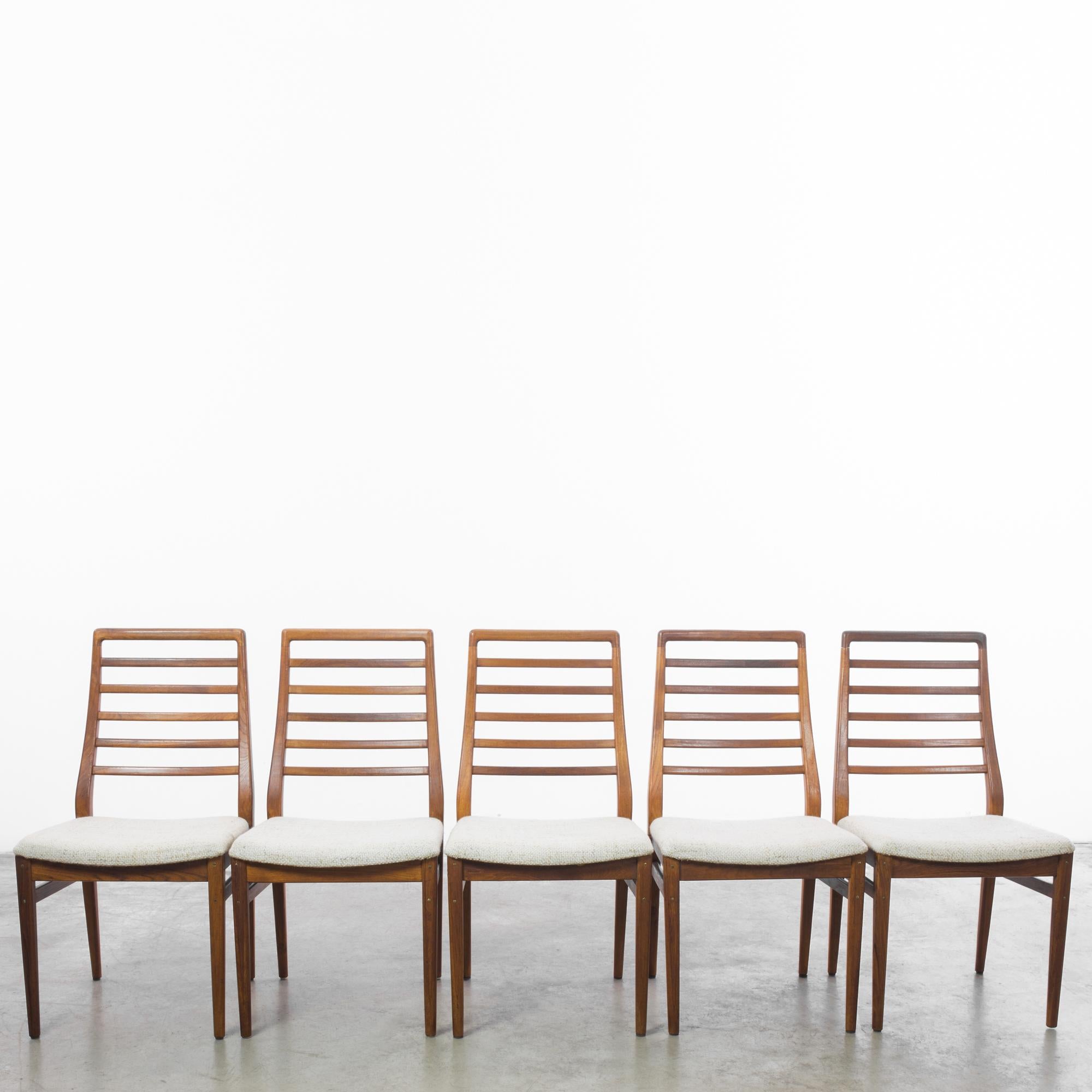 Introducing a set of five 1960s Danish Wooden Chairs, each piece a harmonious blend of form and function, embodying the minimalist elegance of mid-century design. Crafted with the precision of Danish craftsmanship, these chairs feature clean lines