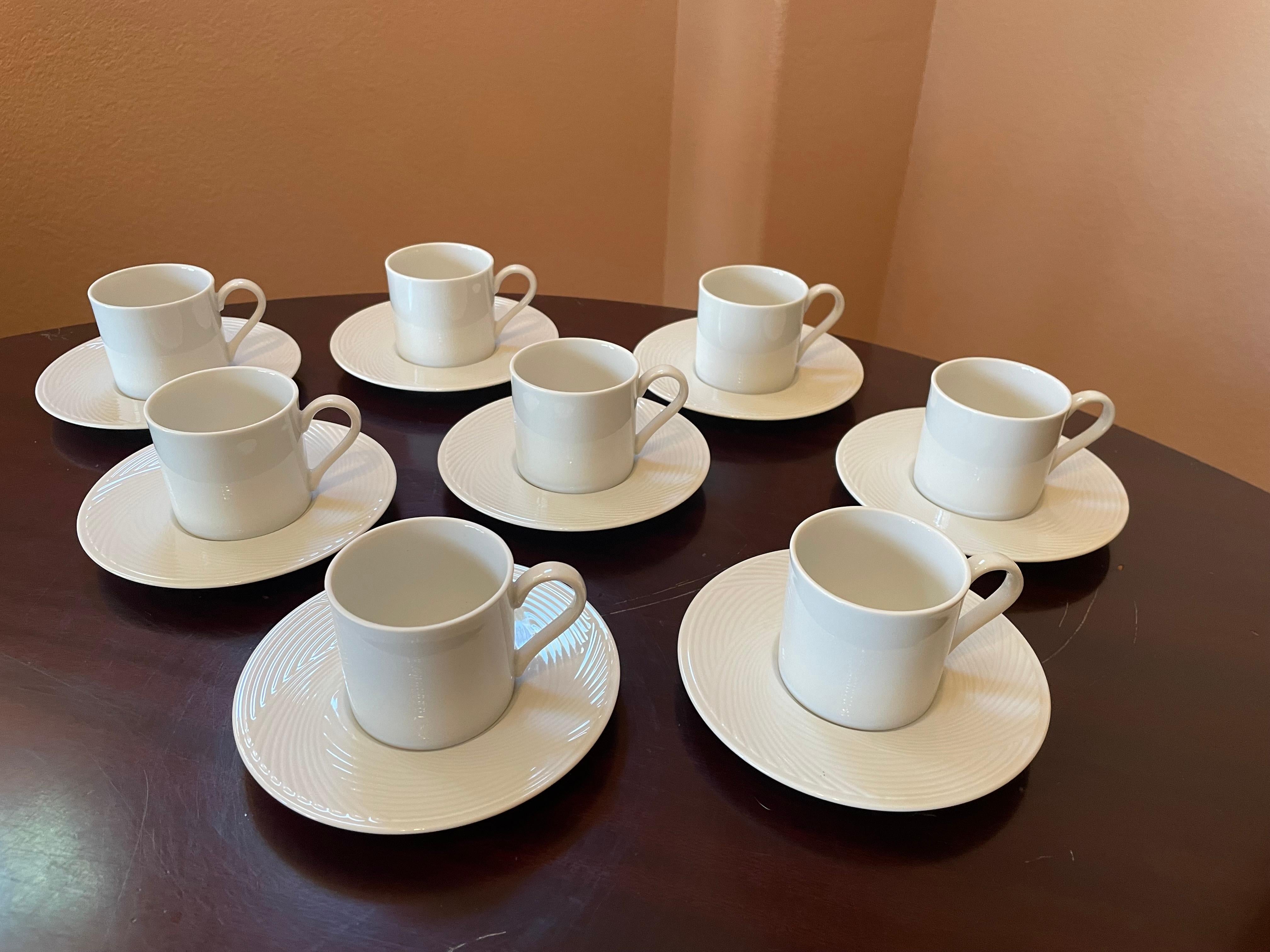 This vintage set of eight porcelain Dansk demitasse cups and saucers is in perfect condition! The color is 'Winter White.' The cup, made of a smooth porcelain and designed with simple graceful line, is combined with the saucer that has a subtle