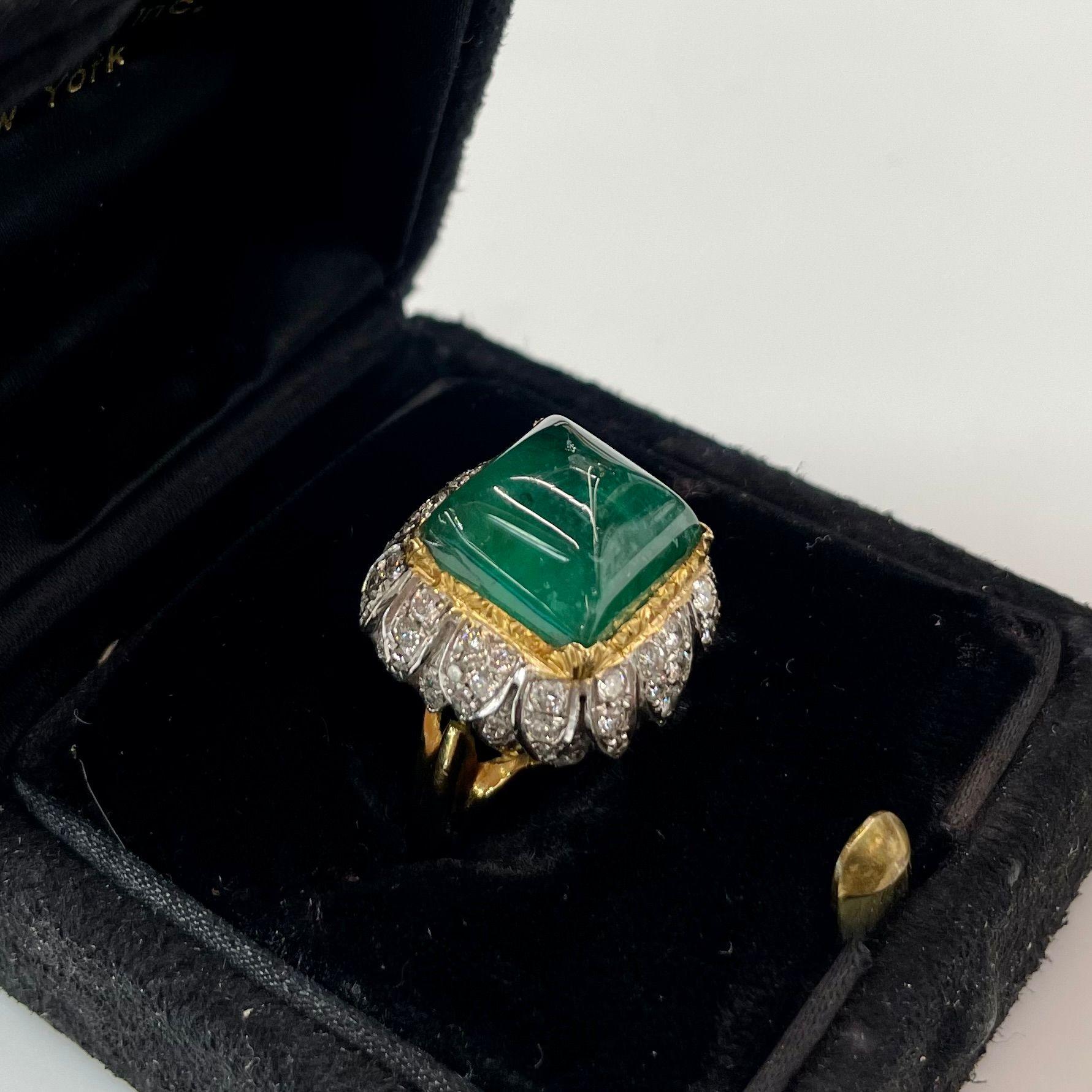 The David Webb 18k yellow gold ring from the 1960s with a genuine green emerald of a sugarloaf cut and round cut diamonds in platinum carriage is definitely a unique and luxurious item.

David Webb was a well-known American jewelry designer who