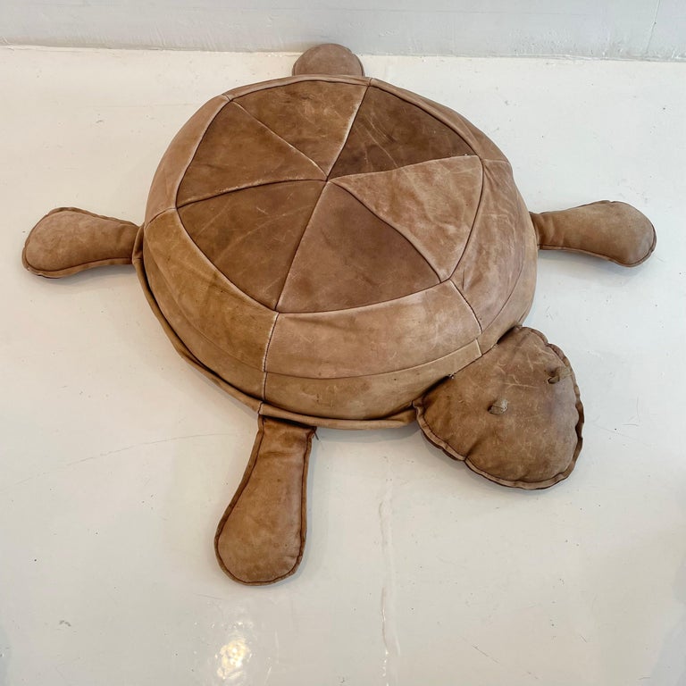 Rare turtle shaped ottoman by Swiss designer De Sede. Circa 1960s. Very heavy and well made. This fun and unique turtle shaped ottoman can be used as a sitting stool or a decorative piece. Pretty cognac patinated leather in good vintage condition.