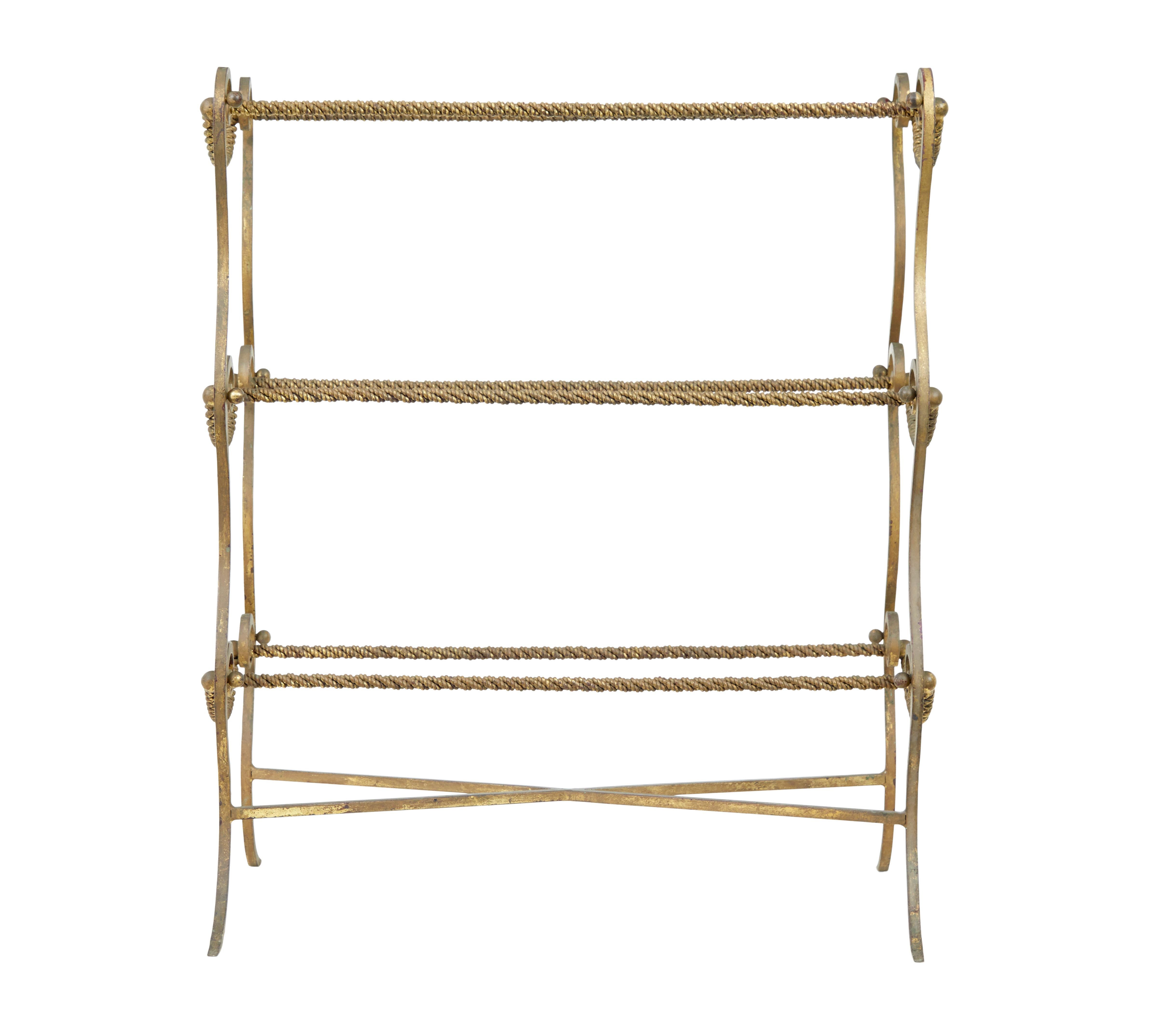 1960’s decorative metalwork towel rail.

Rococo style towel rail, hand crafted rope twist metal work, providing 3 double sided tiers for suspending towels or clothes.  Good proportions that won't overtake a room.  Brass/gilt effect paint now showing