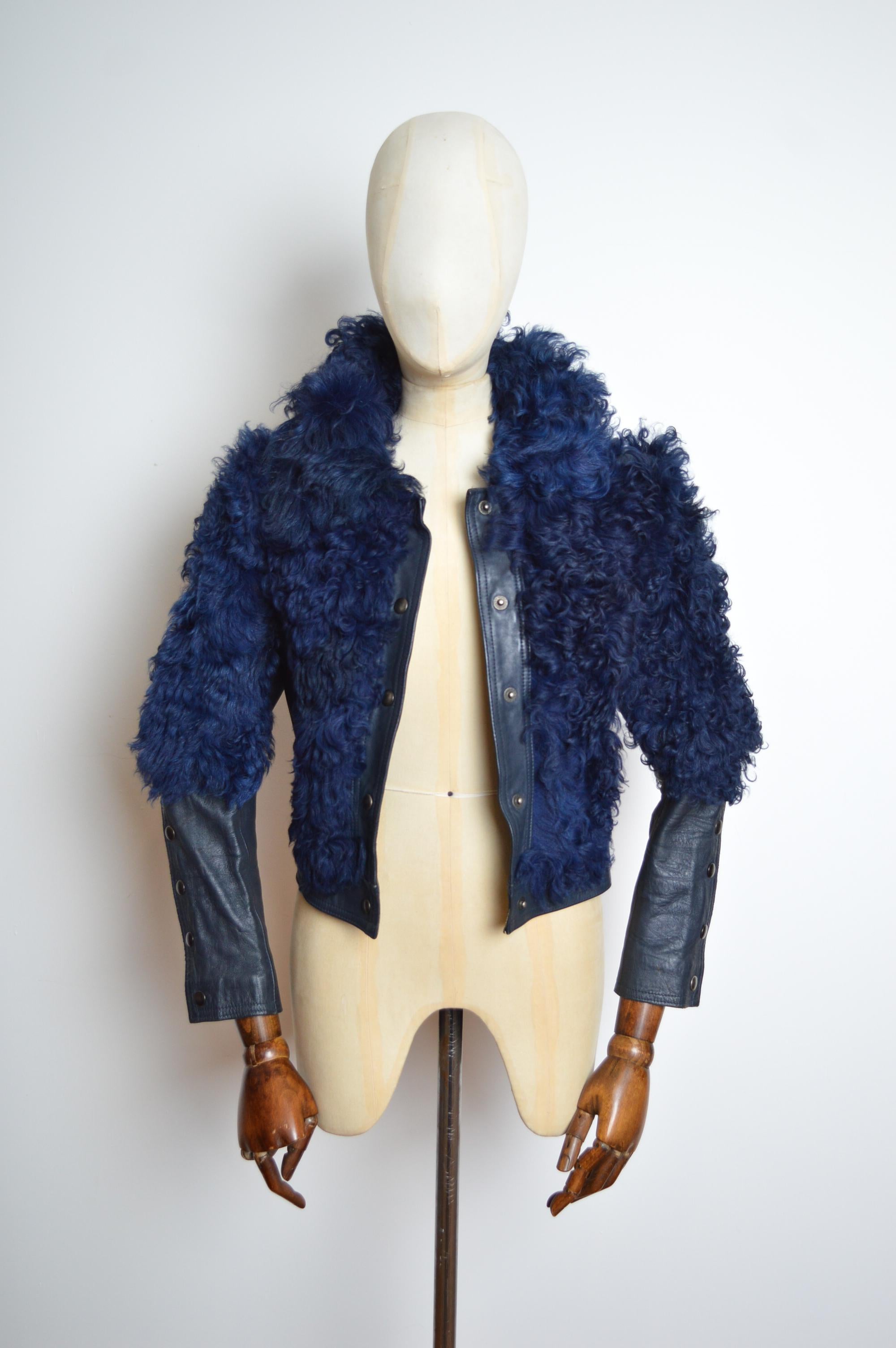 Incredible 1960’s Glam Rock Curly Lamb shearling by ‘Armarel Créations of Paris’ in a deep midnight blue shade featuring Juliette sleeves that can be worn open or closed, satin lined interior and press stud button closure down the front. 
Pit to