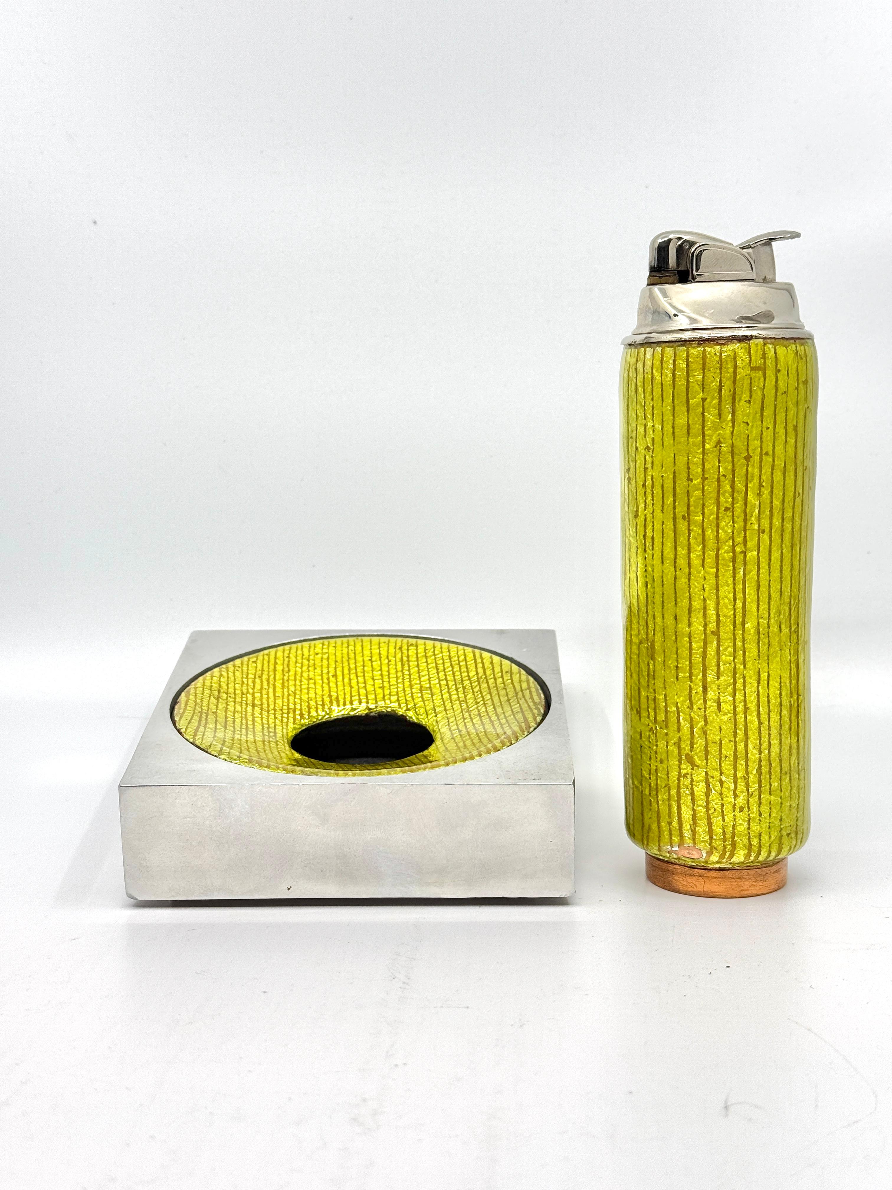 A nice Del Campo Studios set from the 1960’s in an Enamel yellow-green color. Both pieces are marked Del Campo, Italy. The lighter is approximately 6.25 inches tall and the ashtray is 4.25 inches square. The enamel on both pieces has some minor