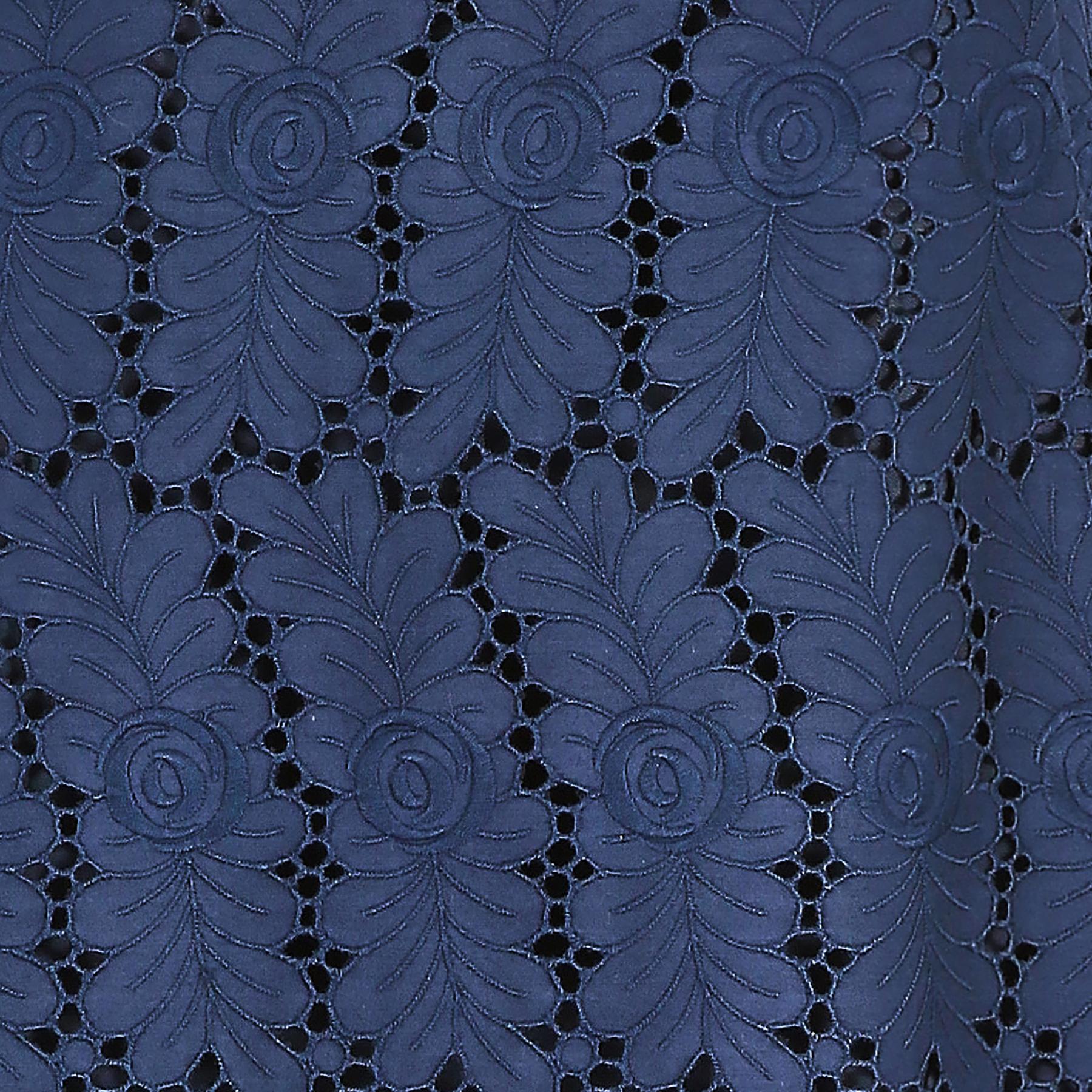 Sophisticated and very well made cap sleeve 1960s shift dress from Dellwood.  Made up of a polished cotton / silk feel fabric with machined cutout work that has been shaped into a stylistic floral arrangement of petals or leaves with an embroidered