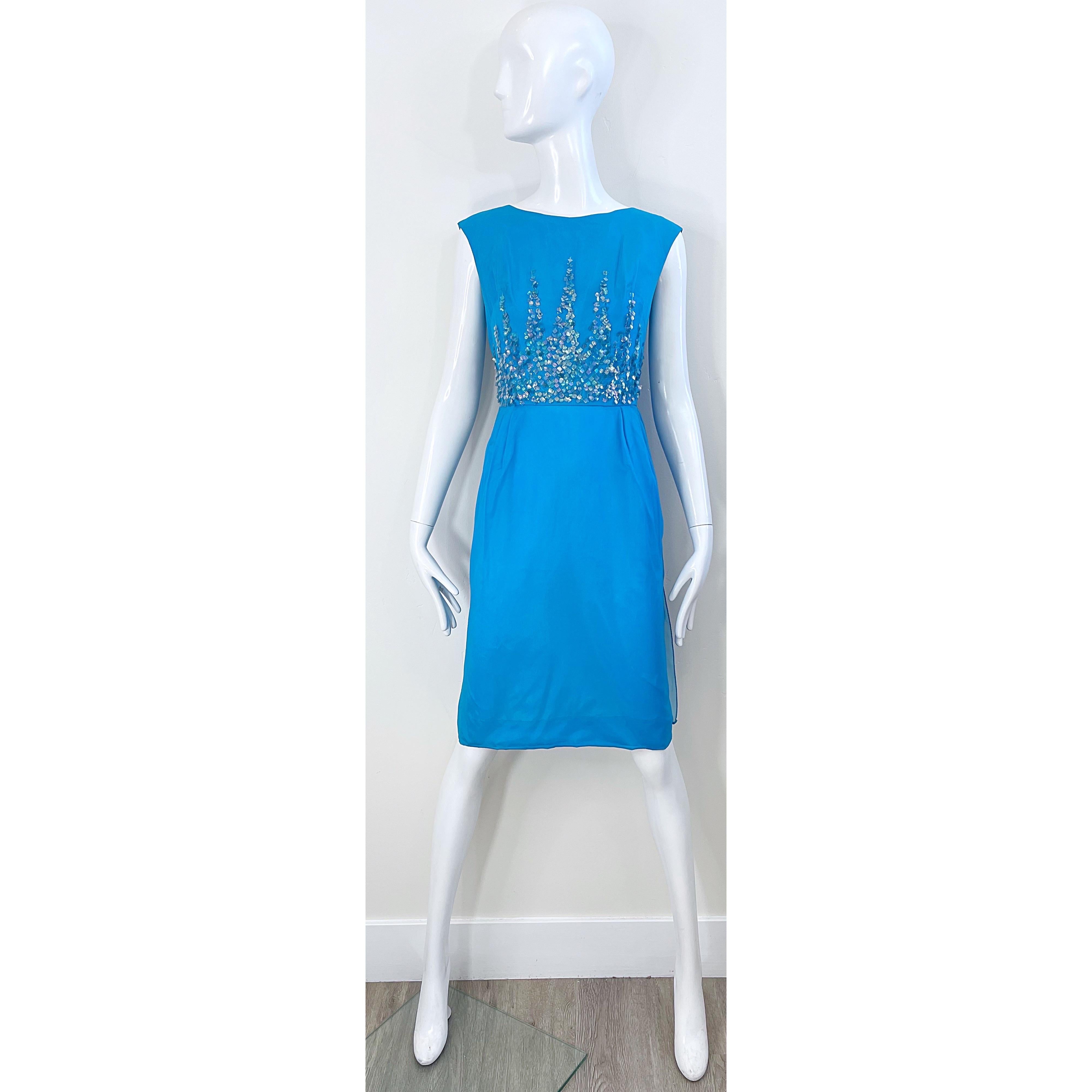 Beautiful vintage 60s demi couture turquoise blue silk chiffon paillette sequin encrusted dress ! Features a tailored bodice encrusted with hundreds of iridescent paillttes. Two panels of chiffon on the back with full mental zipper and hook-and-eye