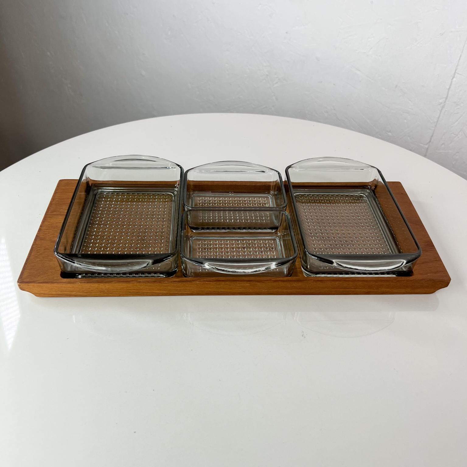 1960s Denmark serving snack tray set teak & glass.
Danish modern set produced by Lüthje Wood Denmark 1 maker stamped.
Measures: 6.38 wide x 13.75 deep x 1.75 tall
Original vintage unrestored condition.
Refer to images.
 