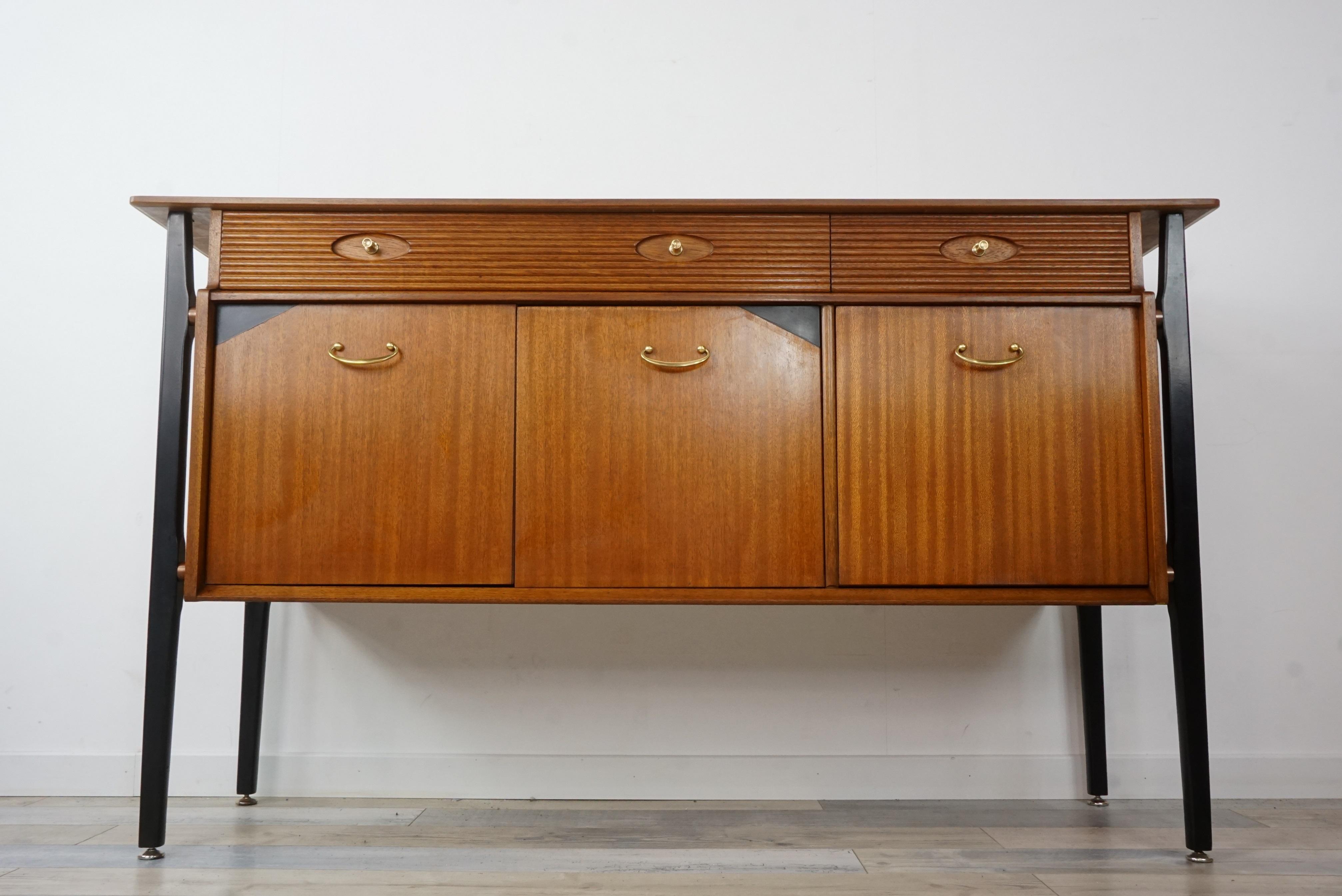 Straight from the 1960s black lacquered and teak wooden sideboard with brass finish.