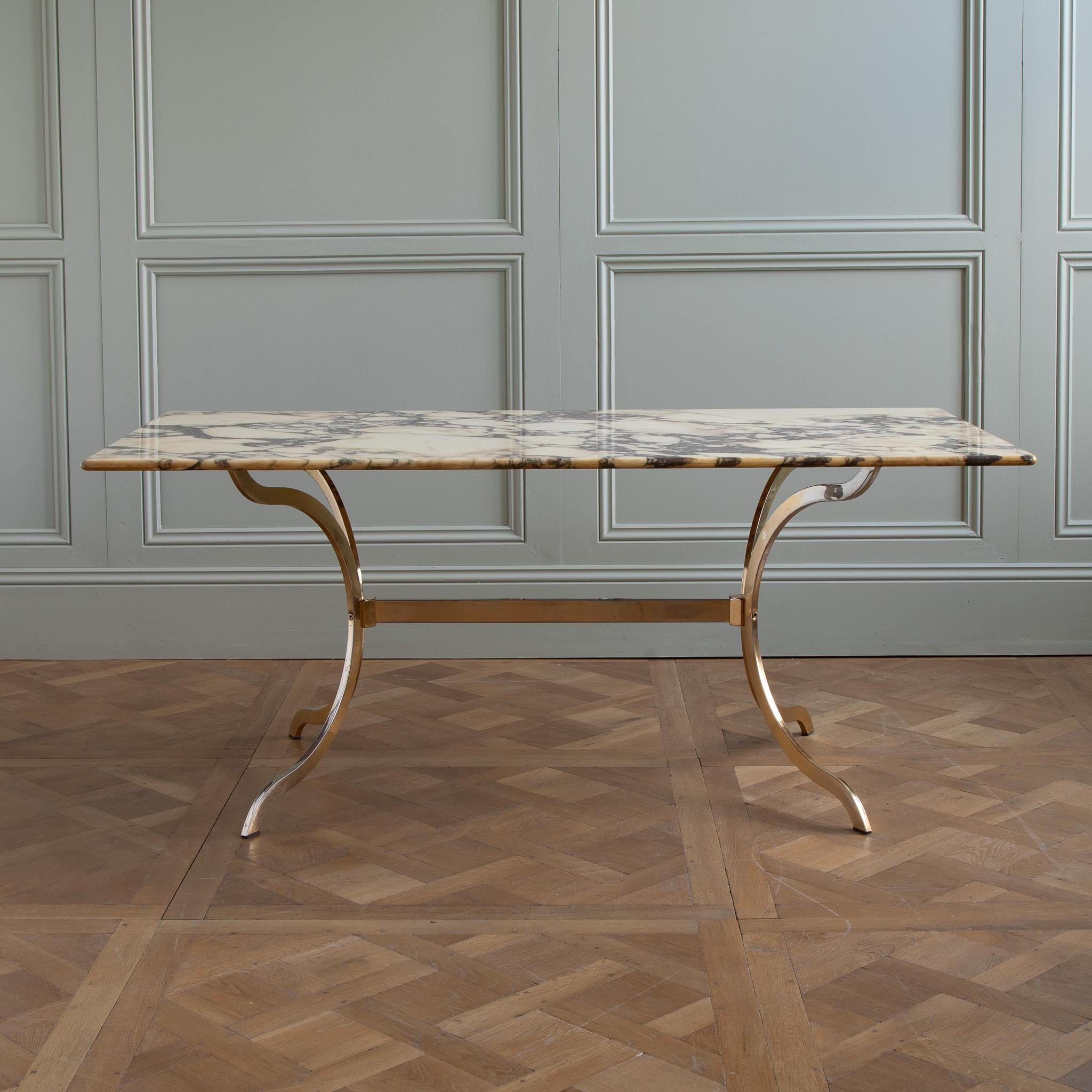 This stunning 1960's designer table is a true masterpiece of mid-century design. The table features a sleek and elegant design with clean lines and a minimalist aesthetic. The table is constructed from high-quality materials, including a beautiful