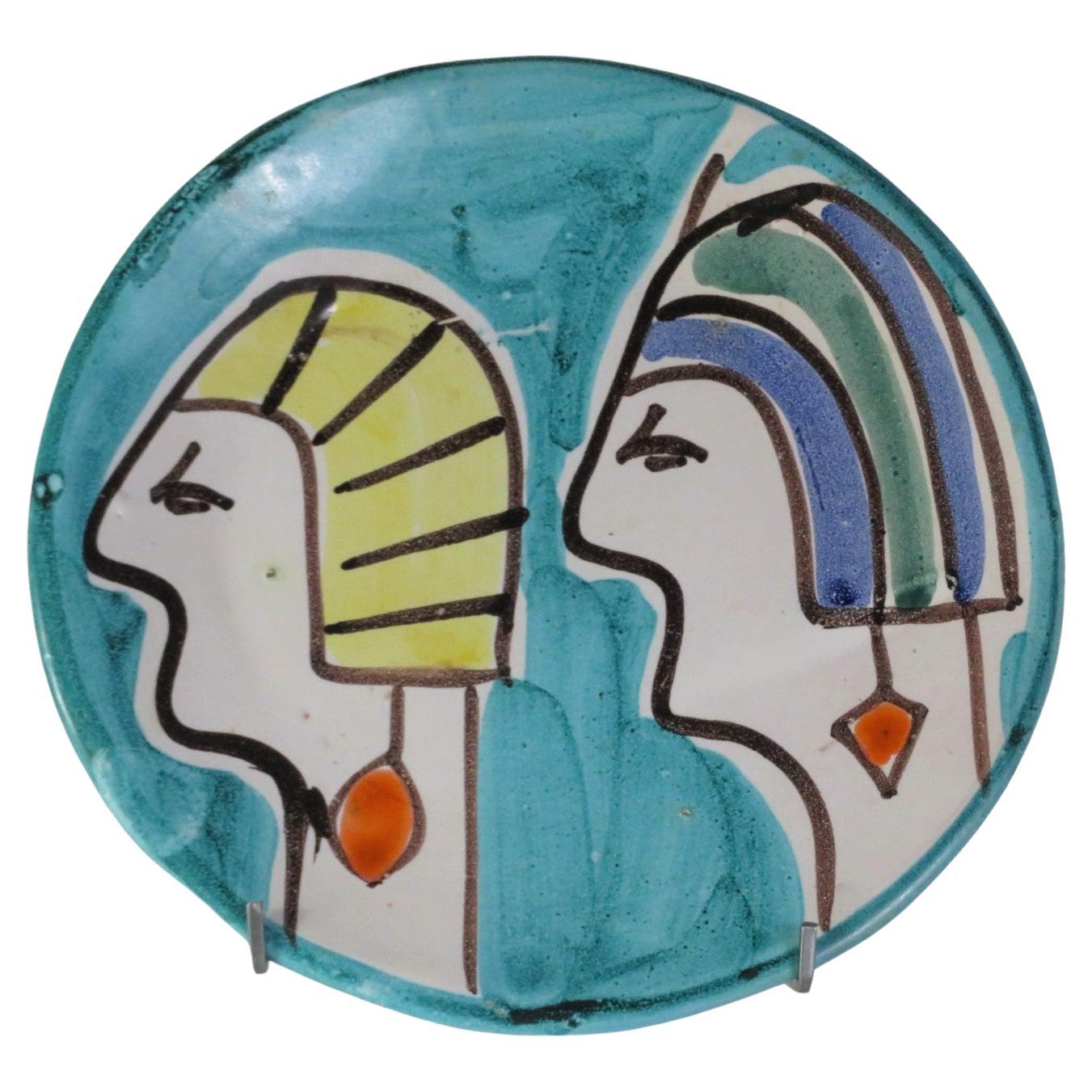 1960s Italian Egyptian themed, hand painted decorative plate. Reminiscent of Desimone painted designs, marked on the back in the clay Italy. The profile of two Egyptian heads facing in the same direction. Probably influenced by the making of the