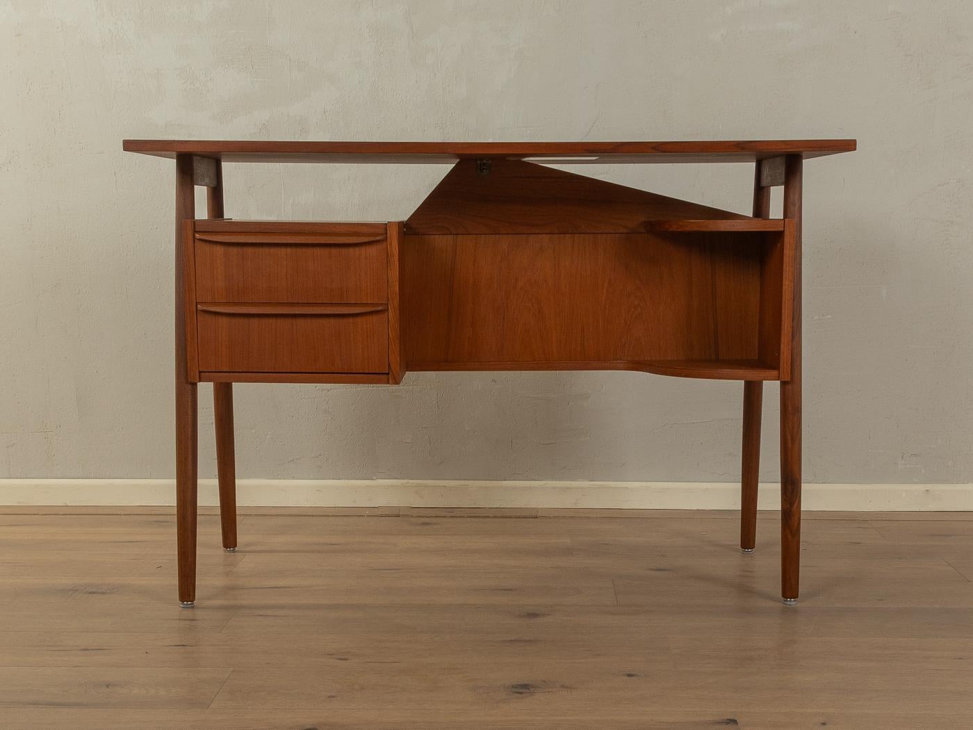 Classic freestanding desk from the 1960s by Gunnar Nielsen Tibergaard. High-quality corpus in teak veneer with two drawers, two shelves, a floating table top, one bookcase on the rear and solid wood legs.

Quality Features:

    accomplished design: