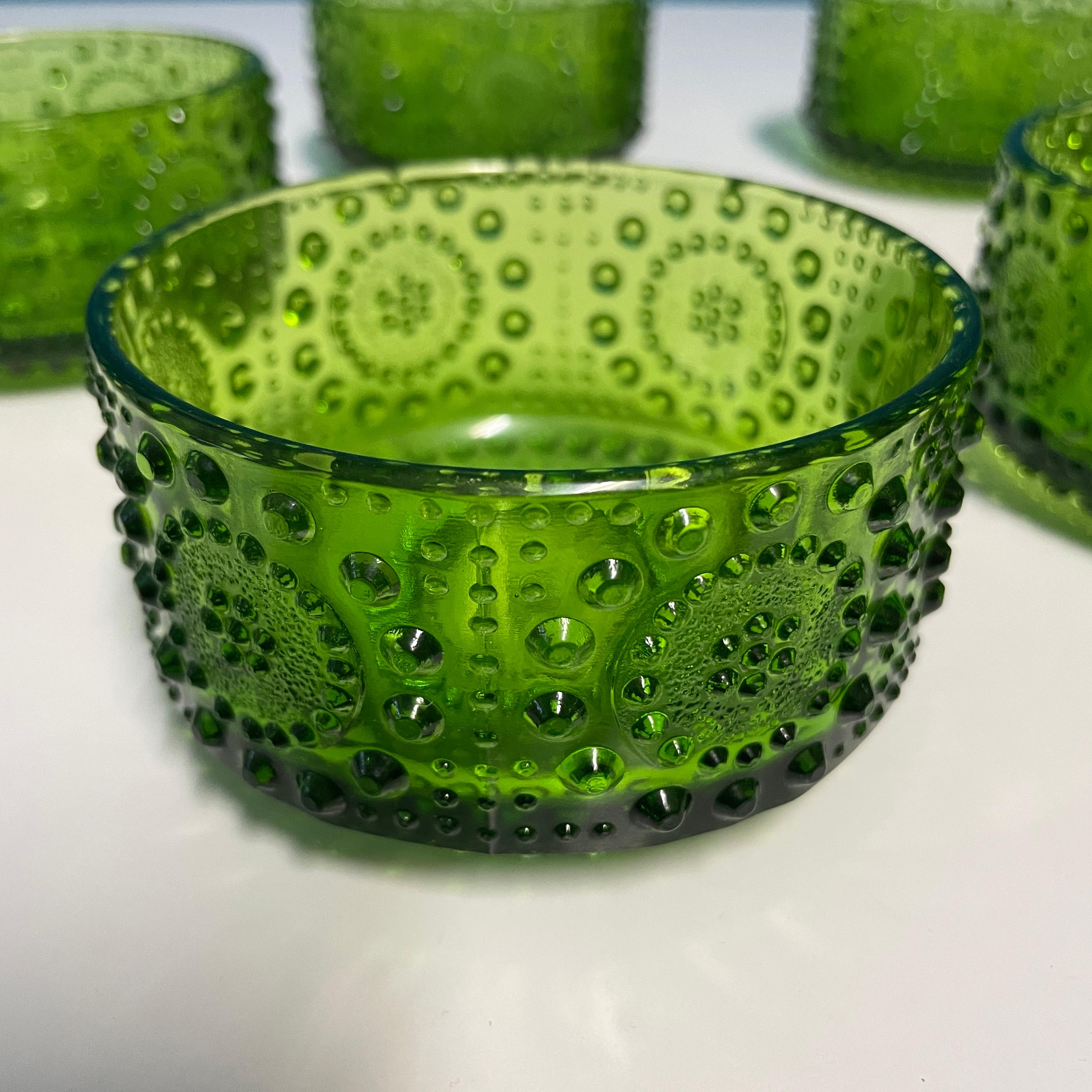 The Grapponia dessert bowl made by Riihimäki Glassworks is part of the Grapponia series designed by Nanny Still in the late 1960s.
These green bowls are decorated with a beautiful hobnail pattern and they are perfect for adding a touch of charm to
