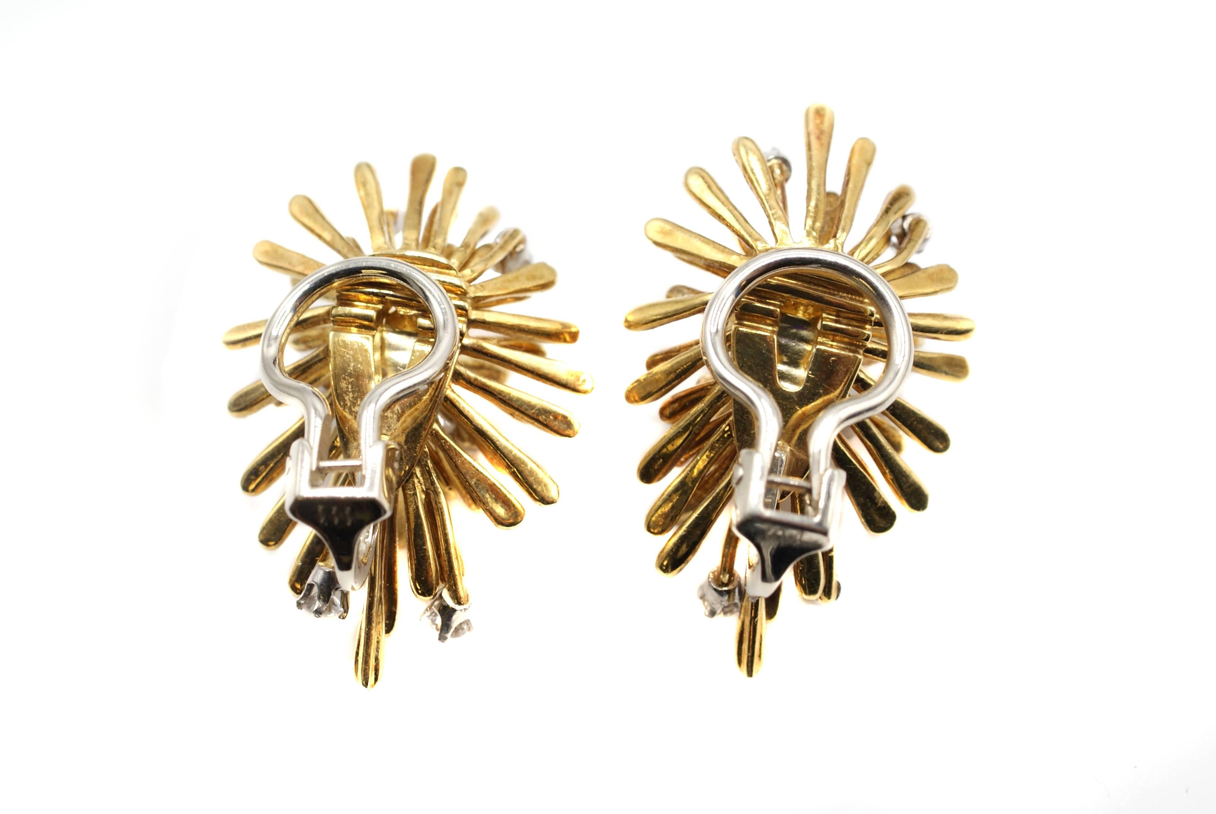 Unique chic 1960s ear clips hand crafted from 18 karat yellow gold. These abstract designed earrings resemble a starburst, with individual graduating polished tubes of gold, some of which are tipped with a bright white and sparkly round brilliant