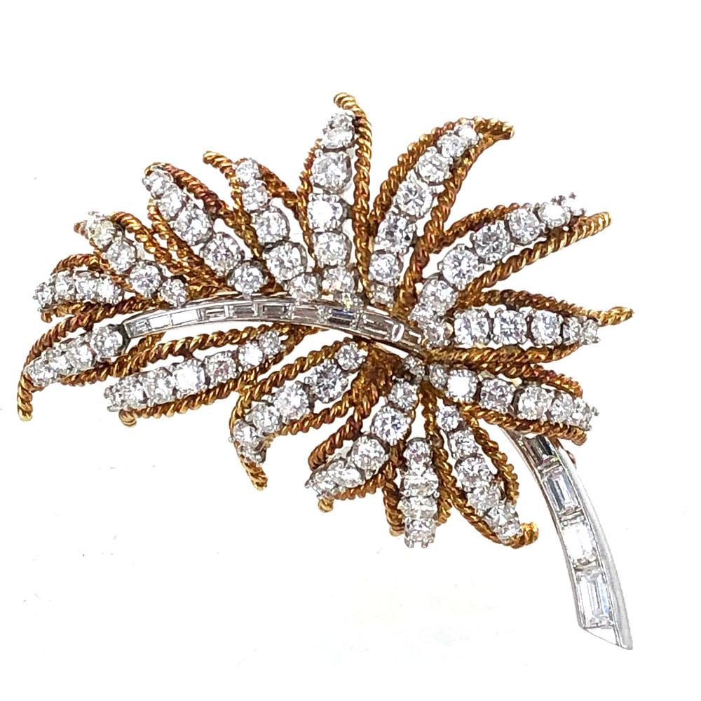 1960's Diamond Brooch fashioned in 18 karat yellow gold and platinum. The leaf shaped pin features 93 round brilliant cut diamonds and 15 baguette cut diamonds are graded F-G color and VS clarity for a total of 5.00 carat total weight. The brooch