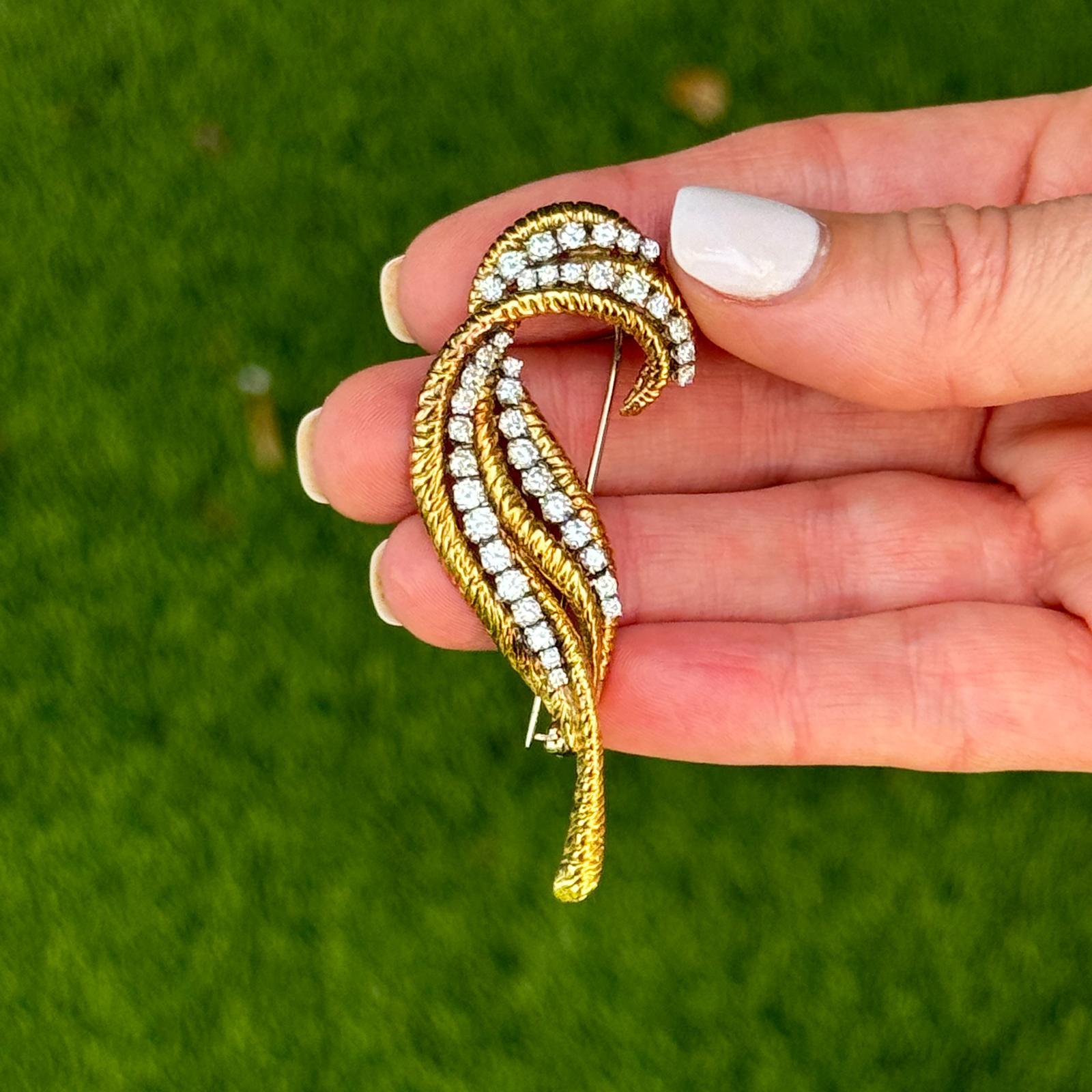 The 1960s Diamond 18 Karat Yellow Gold Vintage Leaf Brooch Pin is a beautiful example of mid-century elegance and artistry. Crafted from luxurious 18 karat yellow gold, this brooch features a detailed leaf design adorned with 40 sparkling round