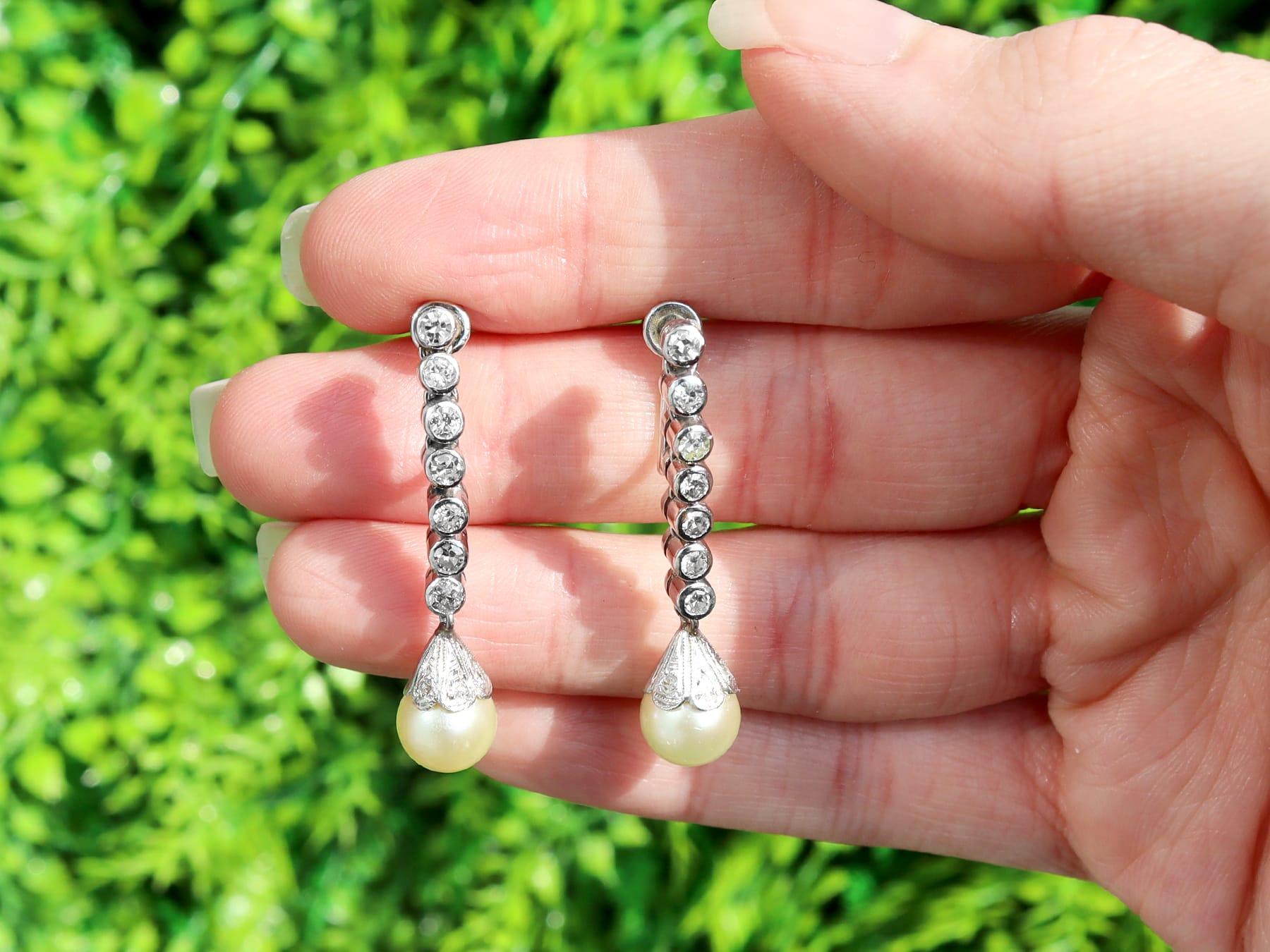 An impressive pair of 0.70 carat diamond and cultured pearl, platinum and 18 karat white gold drop earrings; part of our diverse pearl estate jewelry collections.

These fine and impressive pearl drop earrings have been crafted in platinum with 18k