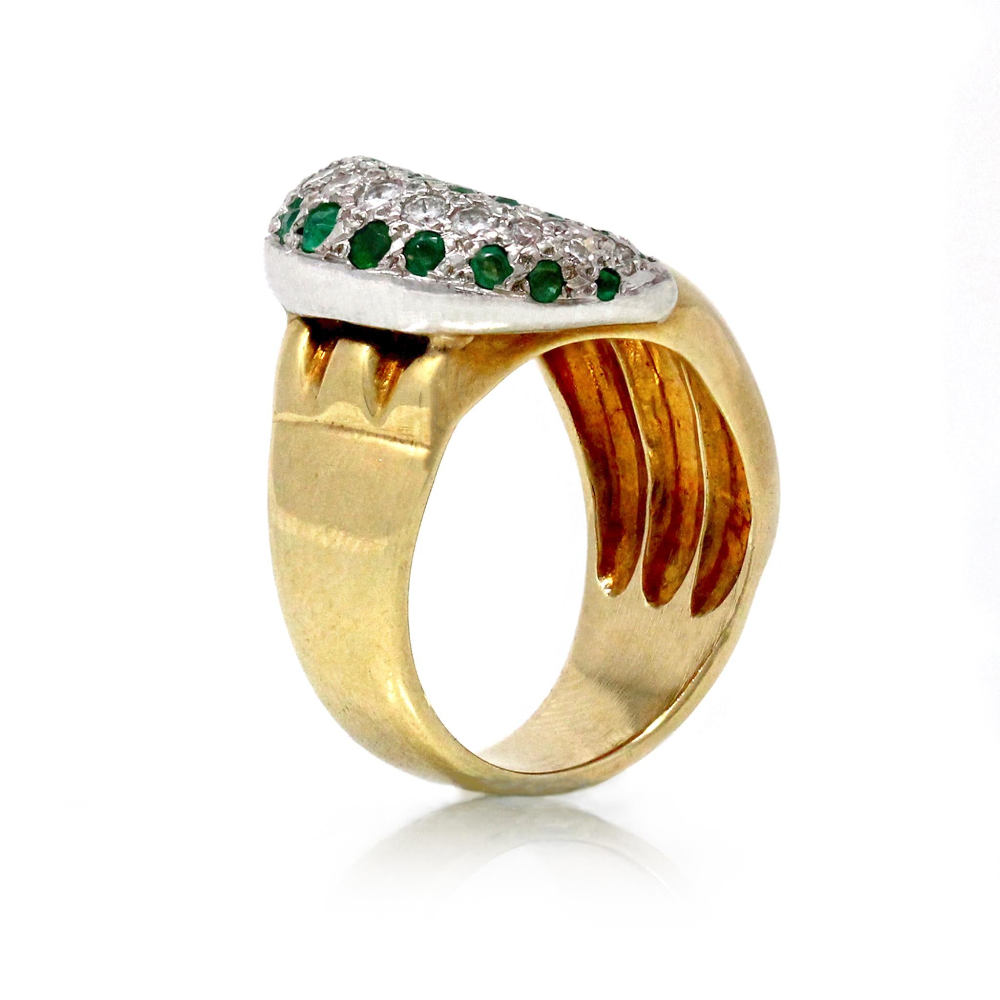 A diamond and emerald two tone 18k gold crescent ring, circa 1960. It is size 6½ and weighs 11.5 grams. Diamond 0.35 carat, emerald 0.55 carat.