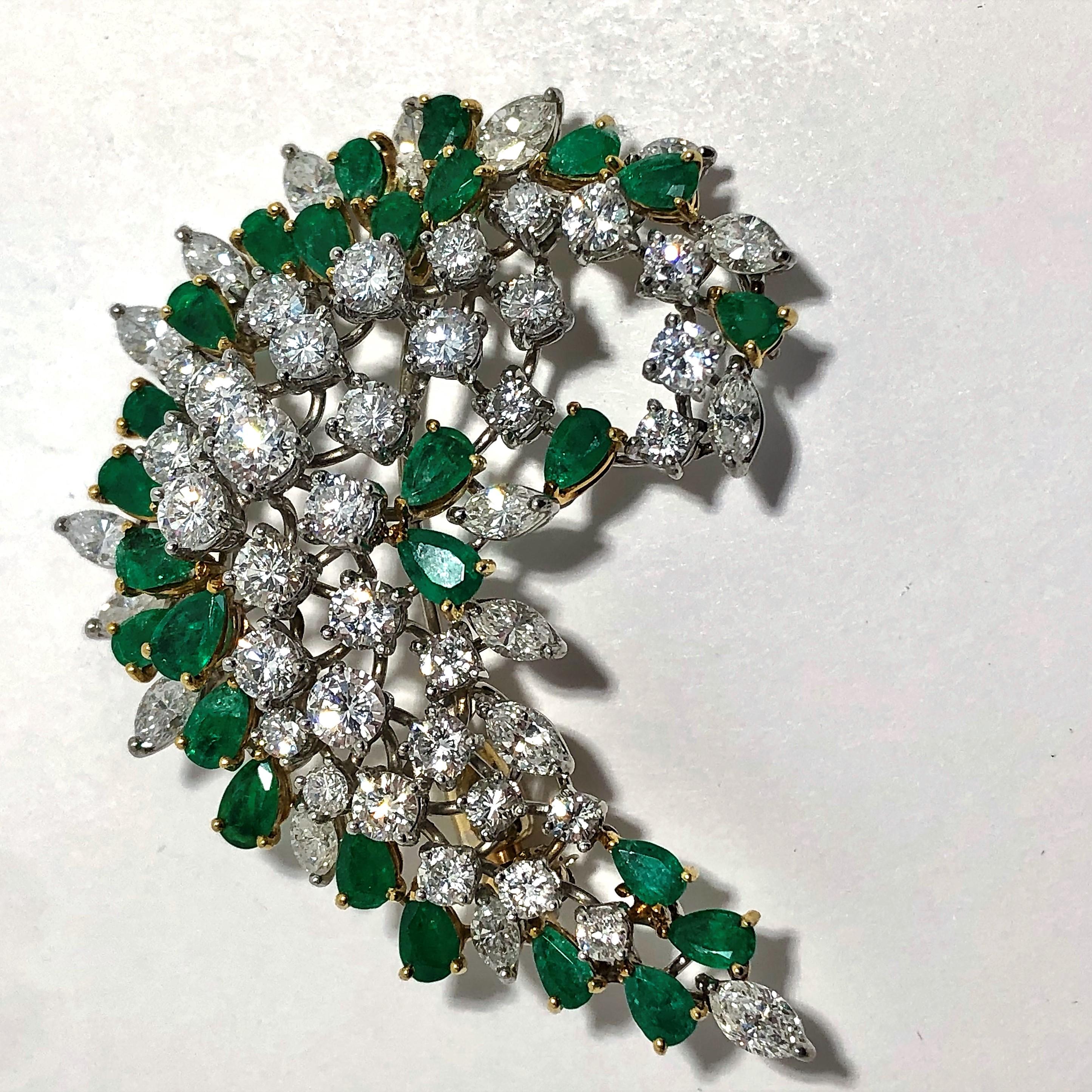 This lovely 1960s, hand made, emerald and diamond swirl brooch by Elwood Van Clief can be worn either as a brooch or as a pendant. Made from platinum and 18k yellow gold, and set with 33 round brilliant cut diamonds, 17 marquise cut diamonds, and 26