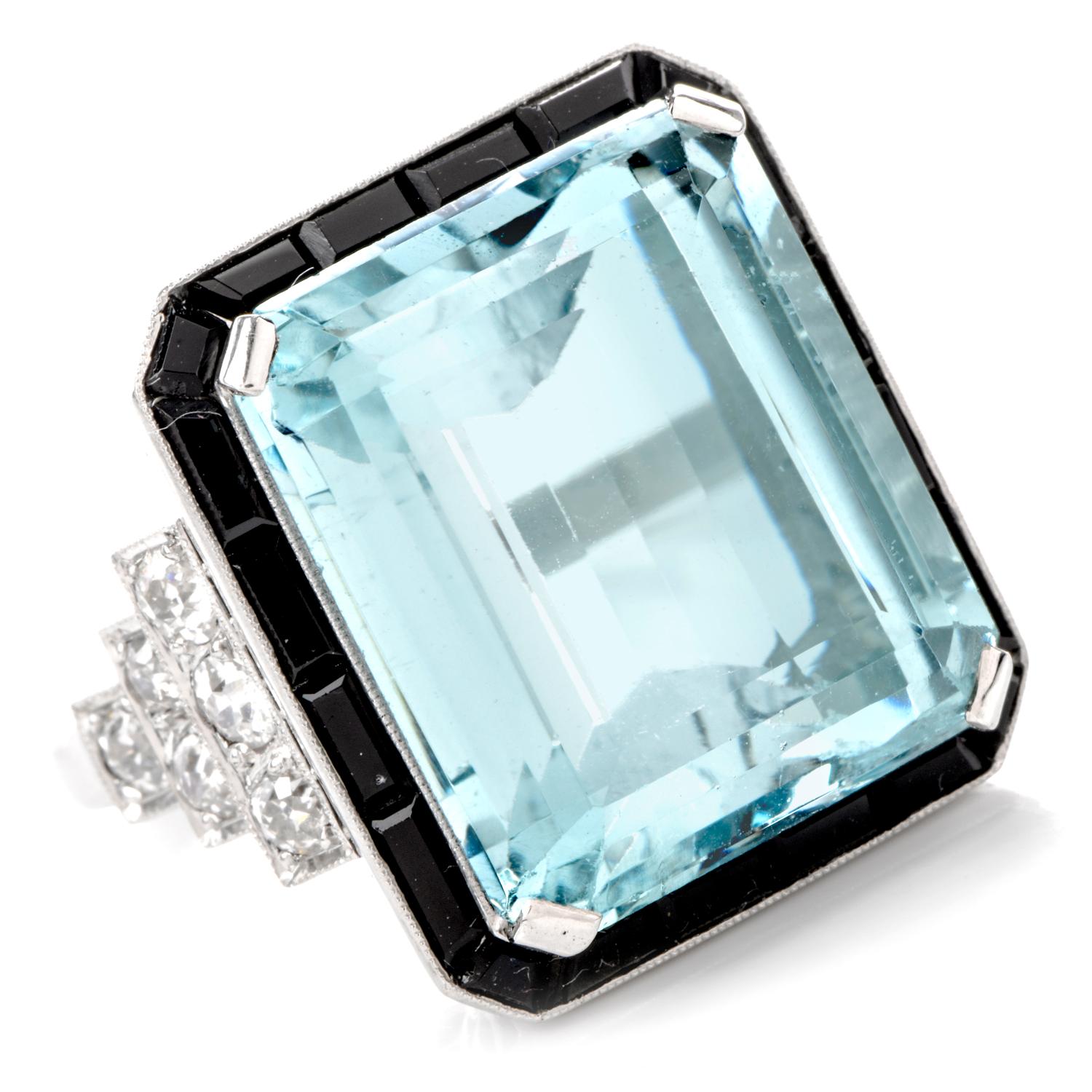 This 1960's Vintage Diamond Aquamarine Onyx ring is inspired in Art Deco and hand crafted in Platinum. Prominently featured in the center is an approximately 28.10 carats of flawless genuine Aquamarine. It is surrounded by channel set rectangular