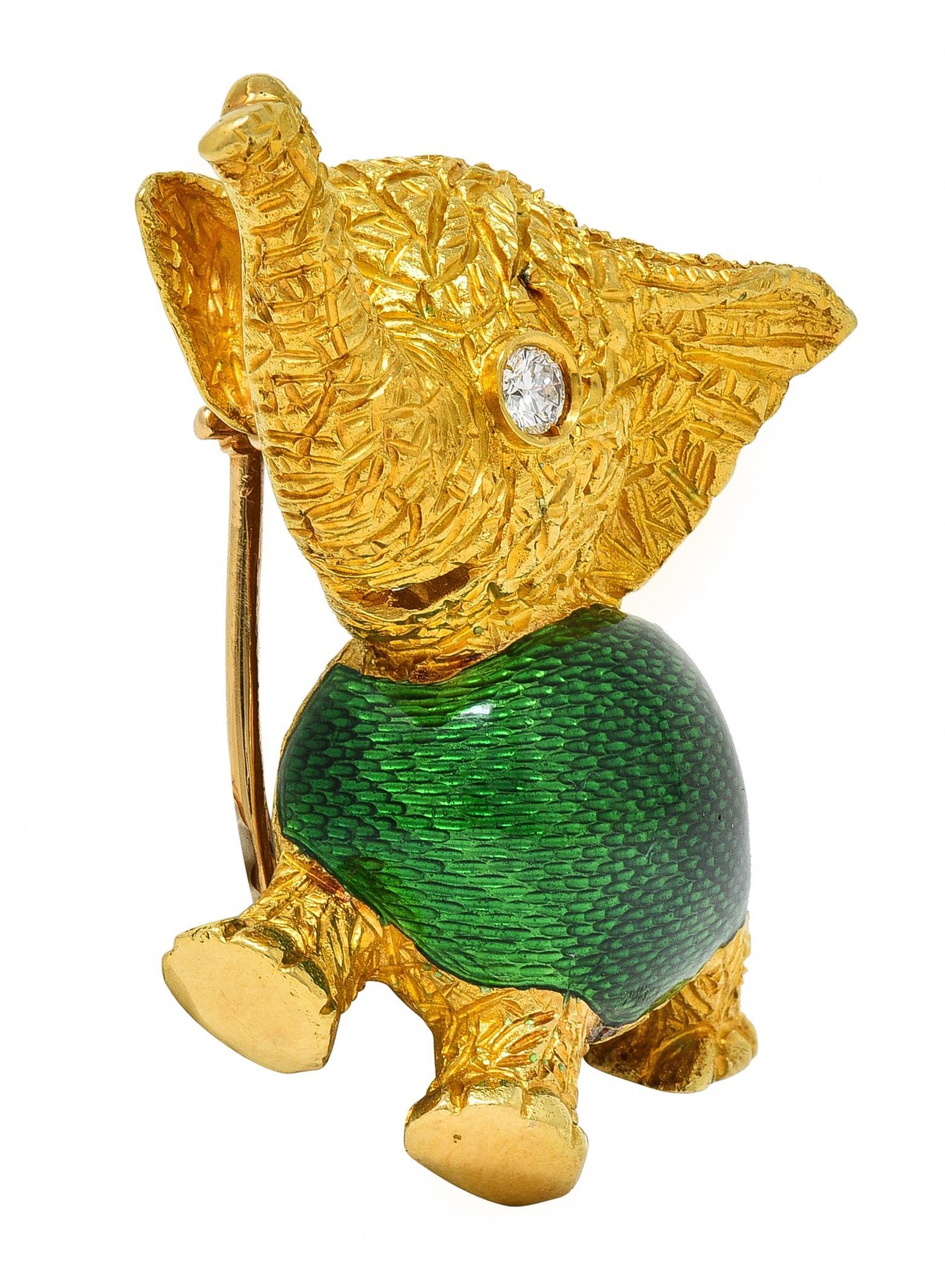 Designed as a cartoonish smiling elephant with textured skin 
With a basse-taille enamel body - transparent green
Glossed over an engraved linear texture 
Accented by a round brilliant cut diamond eye 
Weighing approximately 0.10 carat 
Eye clean