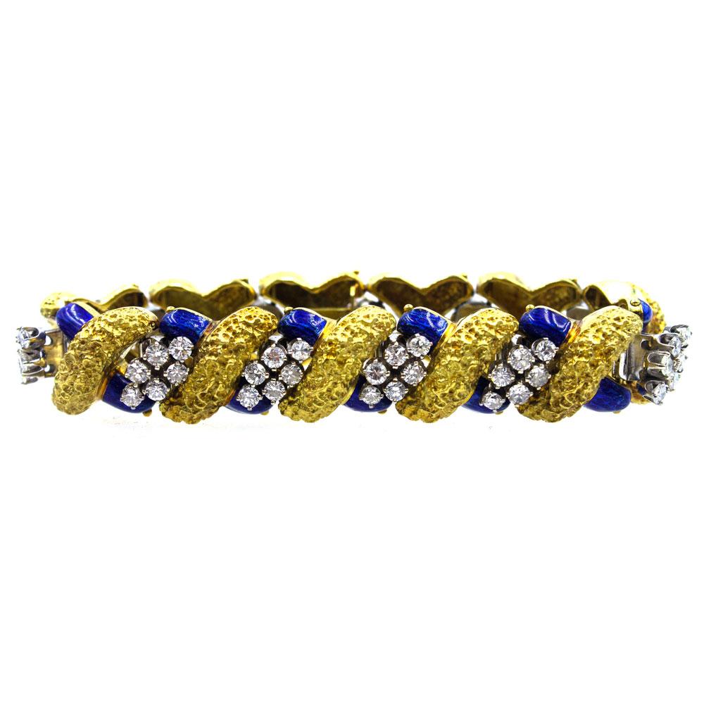 This stunning bracelet features 66 round brilliant cut diamonds set in blue enamel and 18 karat two tone gold. The 6.50 carat total weight of diamonds are graded H-I color and VS2-SI1 clarity. The bracelet measures 7.0 inches in length and .60