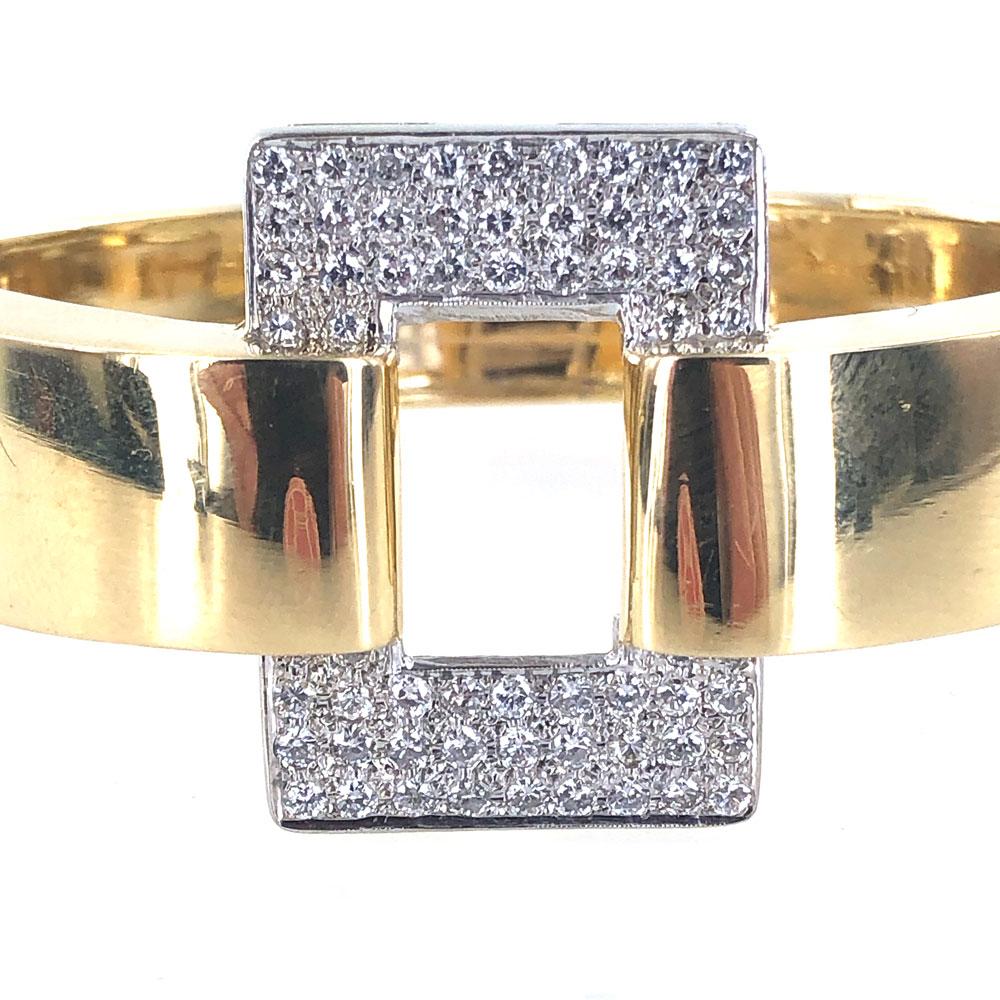 Fabulous vintage buckle bracelet circa 1960's. The 18 karat yellow gold bangle features 1.25 carats of high quality round brilliant cut diamonds graded F-G color and VS-SI1 clarity. The buckle measures 1.25 inches in width, and the back of the