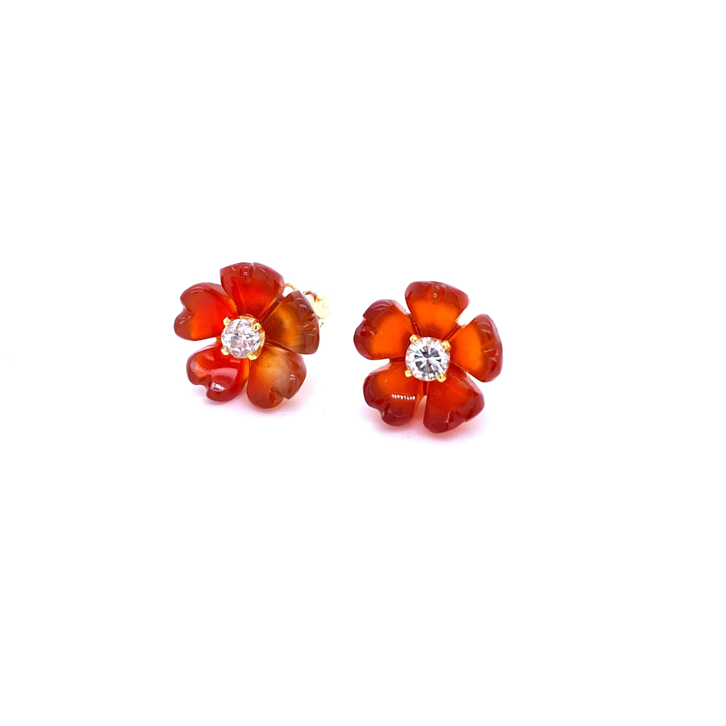 An unusual pair of vintage diamond flower design earrings set in 18k Gold and hand-carved Carnelian. They are set with two large Round brilliant cut Diamonds in the center  for a total weight of 0.54 ct. All graded color F-G clarity Vvs1. 
Origin