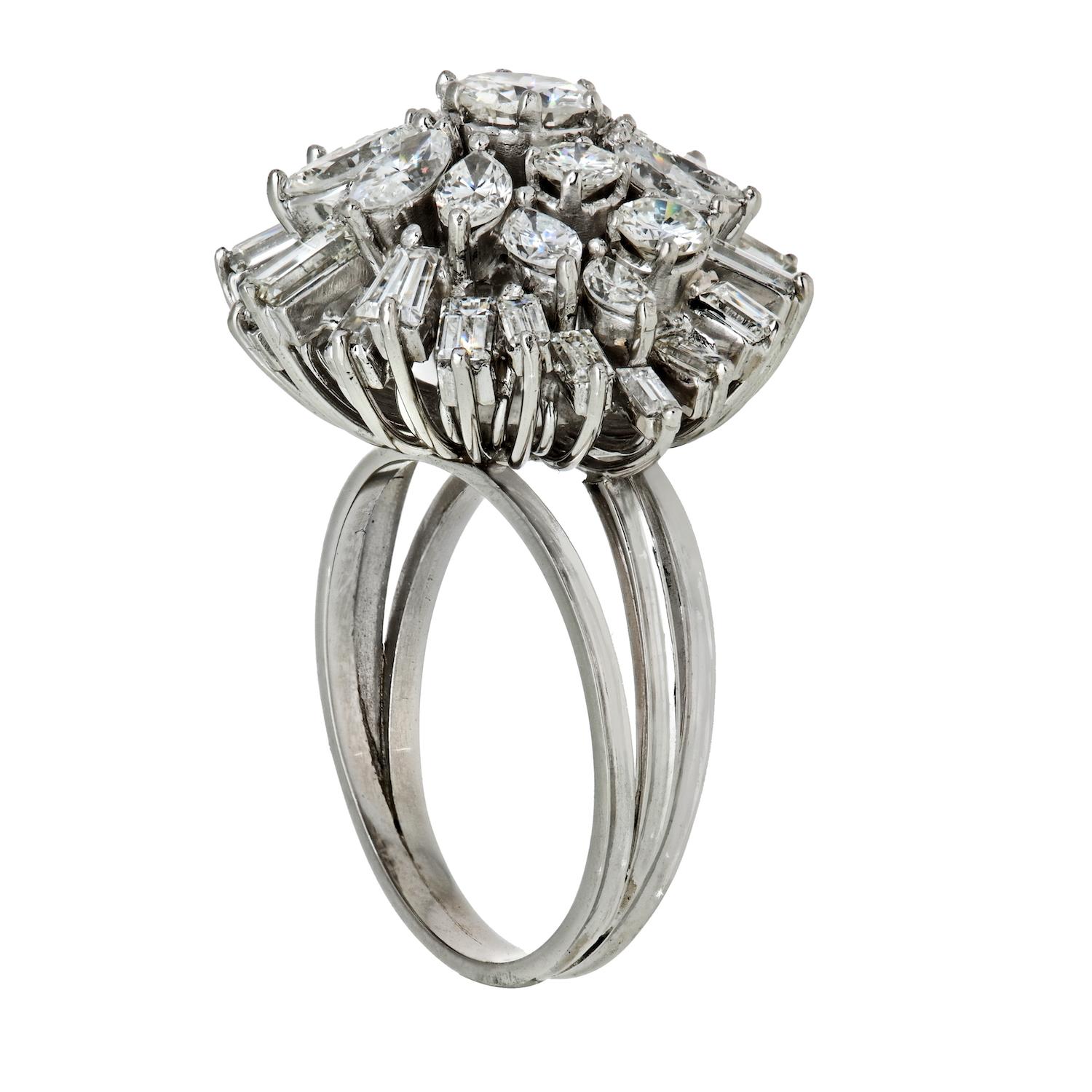 A fine and impressive vintage 5.75 carat and platinum cluster ring; part of our vintage jewelry and estate jewelry collections from 1960's.

This fine vintage diamond cluster ring has been crafted in platinum.

The pierced decorated boat style frame