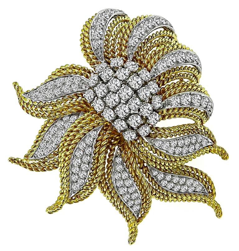 This stunning 18k yellow and white gold pin from the 1960s is set with sparkling round cut diamonds that weigh approximately 4.50ct. graded F-G color with VS clarity. The pin measures 56mm by 48mm and weighs 31.8 grams.
The pin is stamped