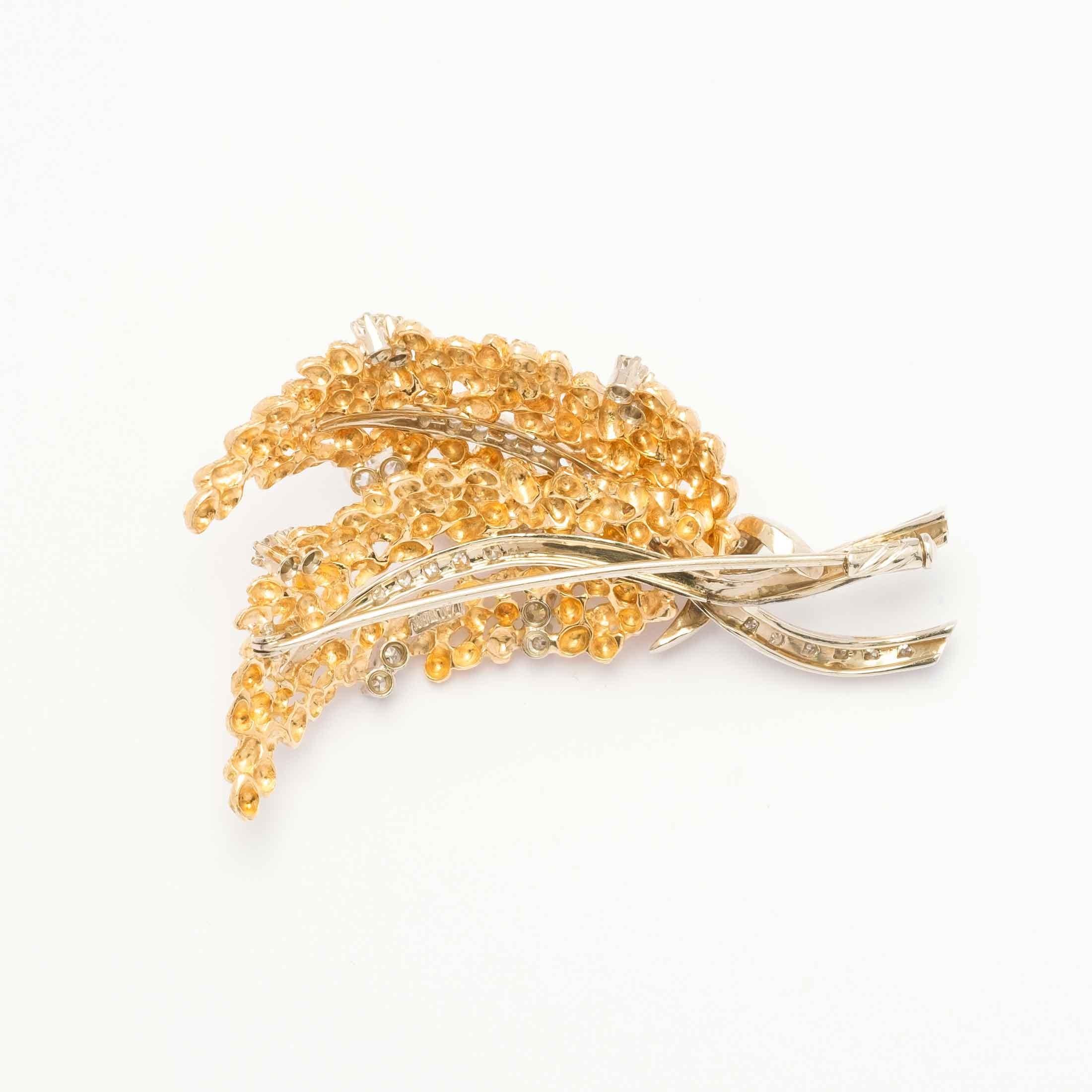 1960s period brooch set in 18ct two tone gold, finely hand made in the shape of two intertwining leaves, highlighted by huit-huit cut diamonds for a total of 1ct c.a. Made in Italy.

Highlights:
- 18ct gold two tone
- Huit-huit cut diamonds for 1ct