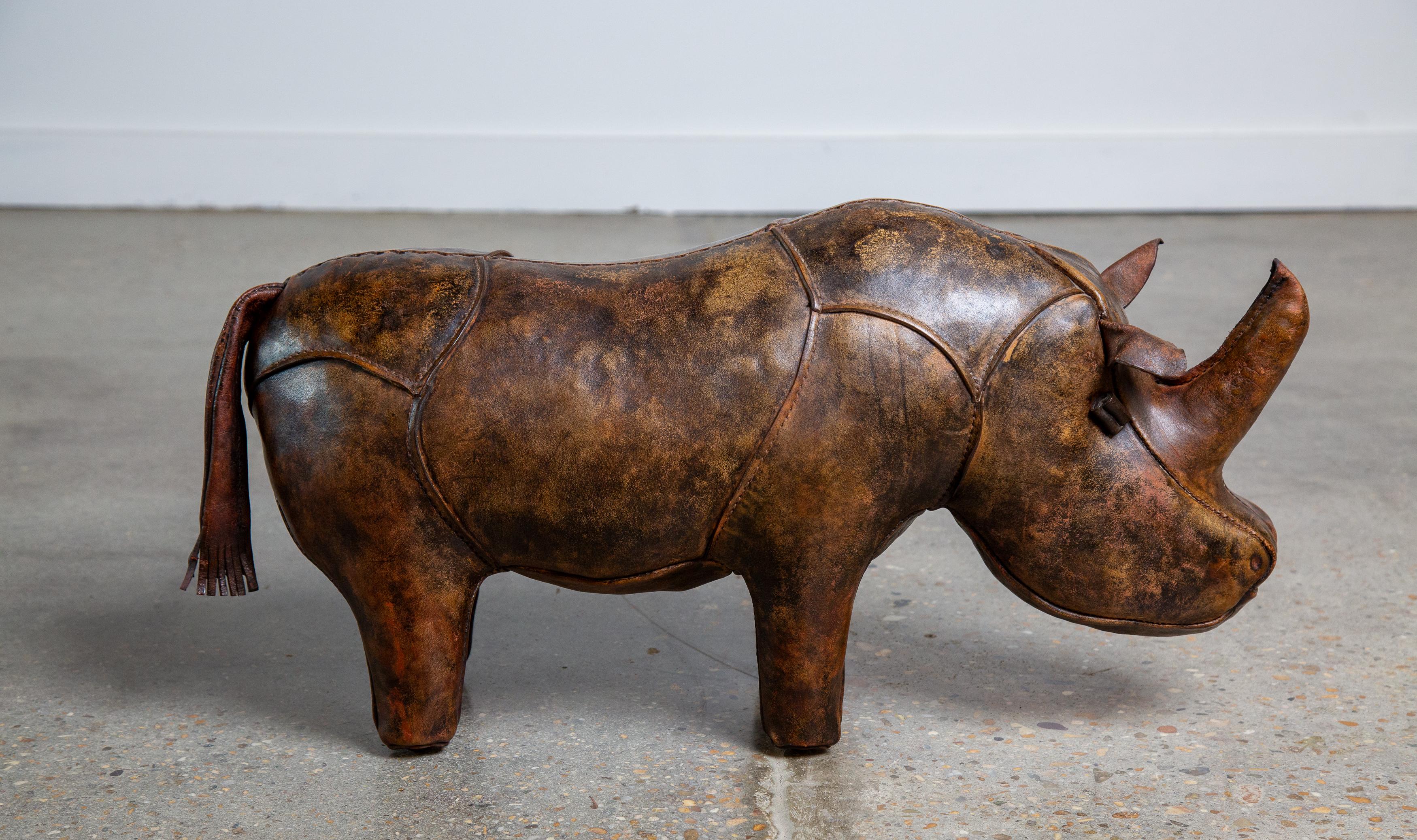 The highly collectable Rhinoceros footstool/ ottoman designed by Dimitri Omersa. Heavy leather patchwork with great patina. This is an older version with nailed on feet.  This piece was purchased from the original owner who bought at Neiman Marcus