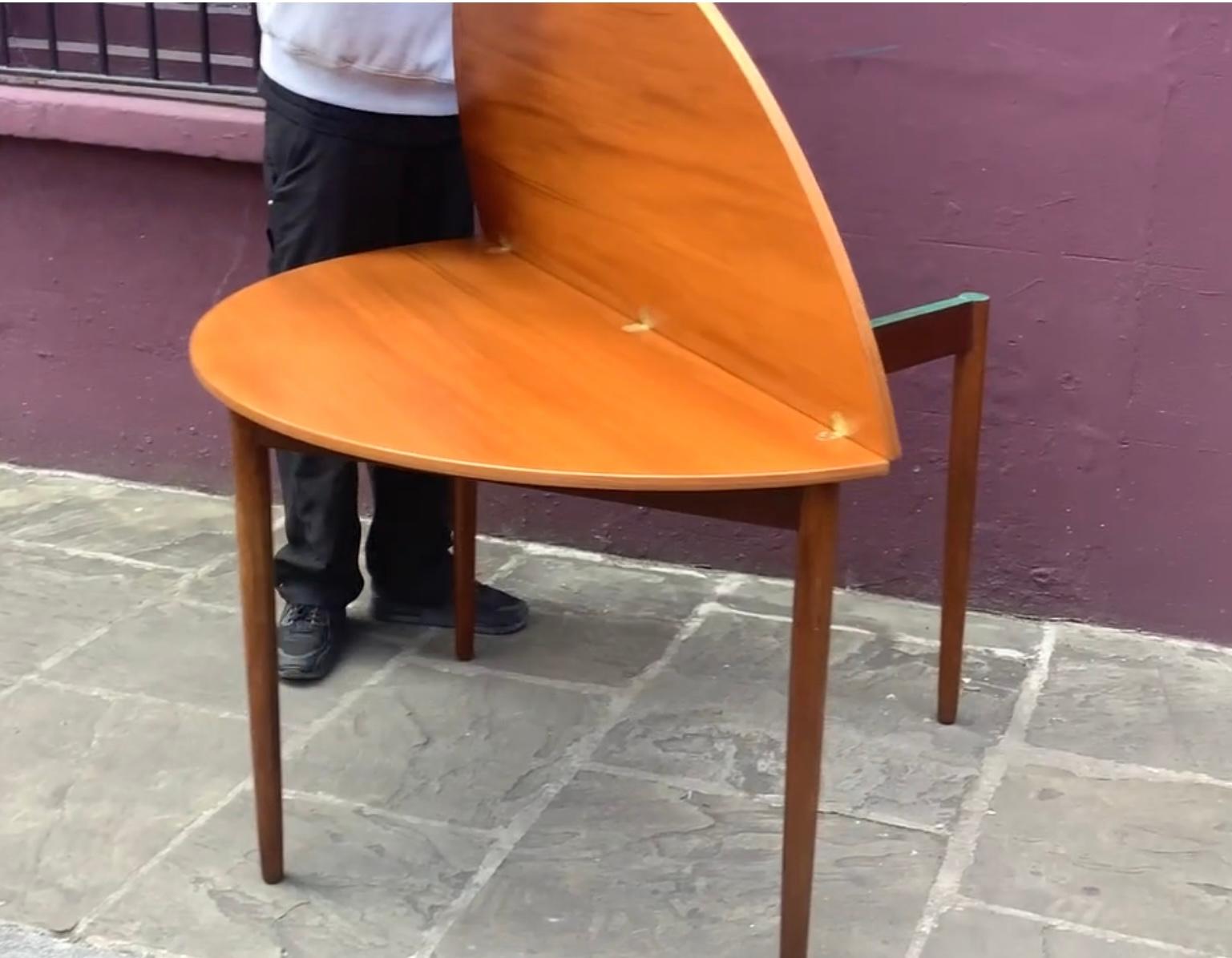 Wonderfully designed drop leaf  table designed to be used against the wall as a

console table .Can be placed in a room as a dining table when  extended 

to full circle .Designed with integrated brass hinges and the 4th leg which pulls out to