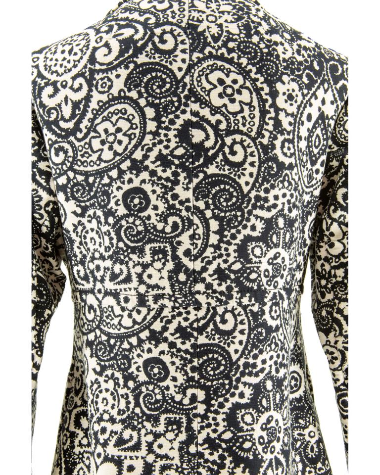 A rare and collectible late 1960’s Diorling by Christian Dior black and white cotton serge fit-and-flare coat, featuring an all-over floral, paisley, scroll and geometric print, with pointed collar, two-piece set-in sleeves, two concealed side
